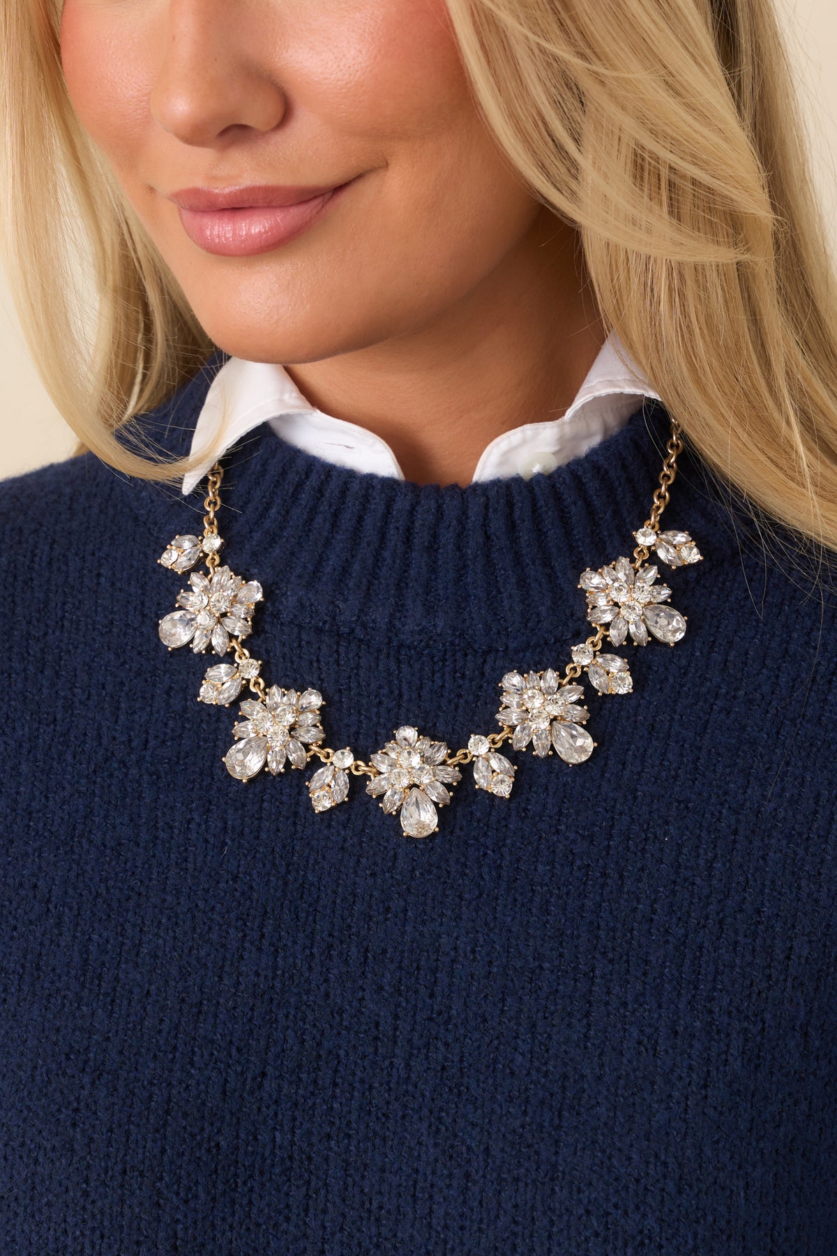Chunky rhinestone accents decorate the gold chain of this statement necklace.