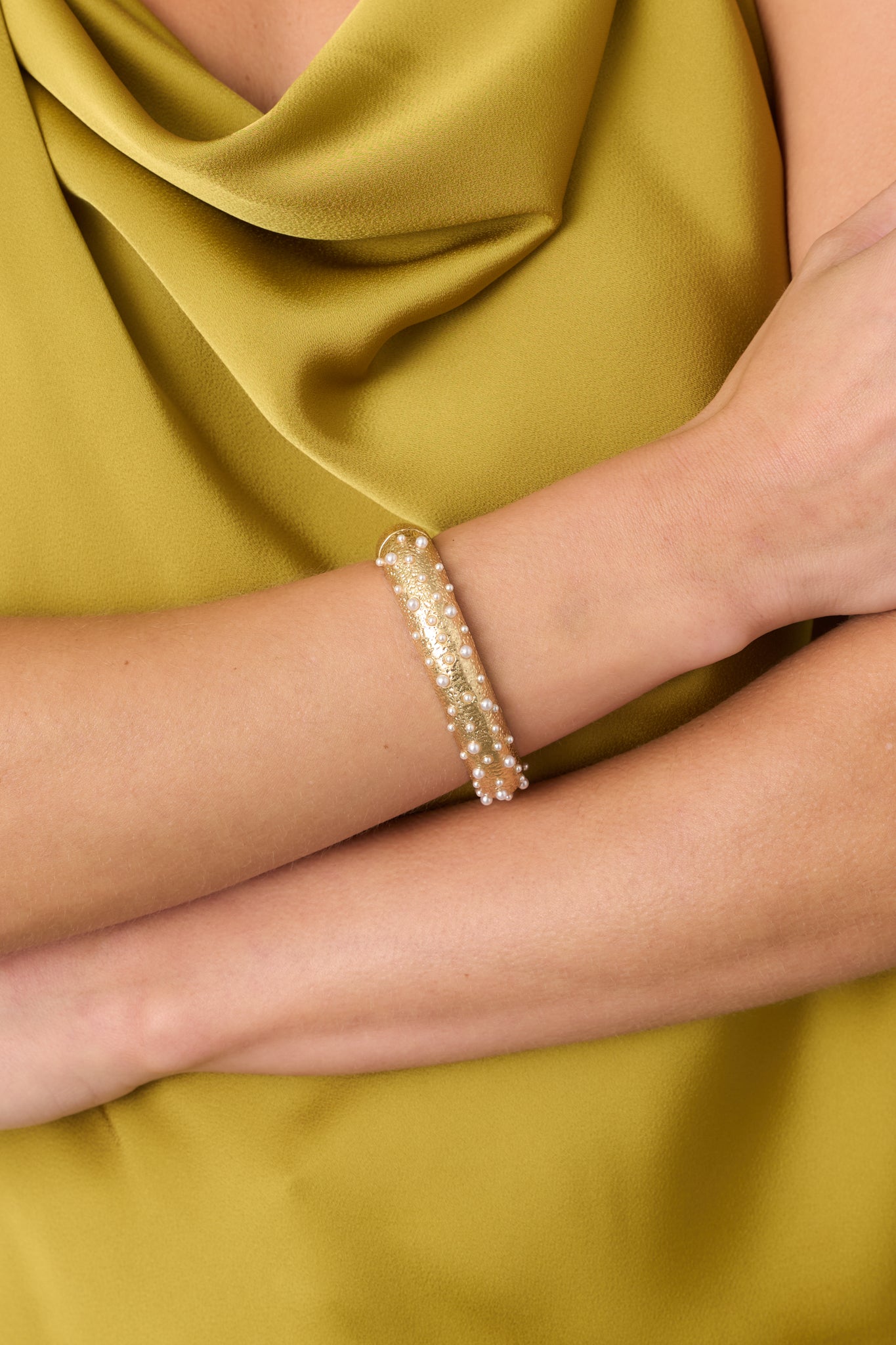 Close-up of the textured gold-tone cuff highlighting the scattered mini faux pearls, dimensional surface, and refined vintage-inspired finish.