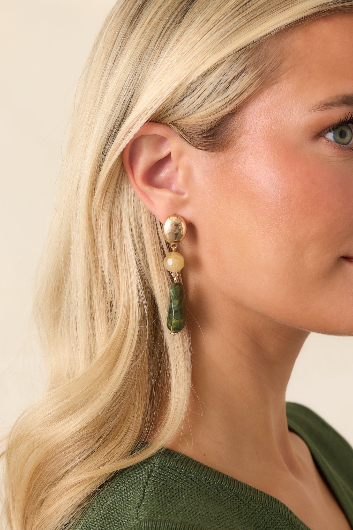 Gold-tone drop earrings featuring faceted honey-colored beads, marbled green bead accents, and an elongated silhouette.