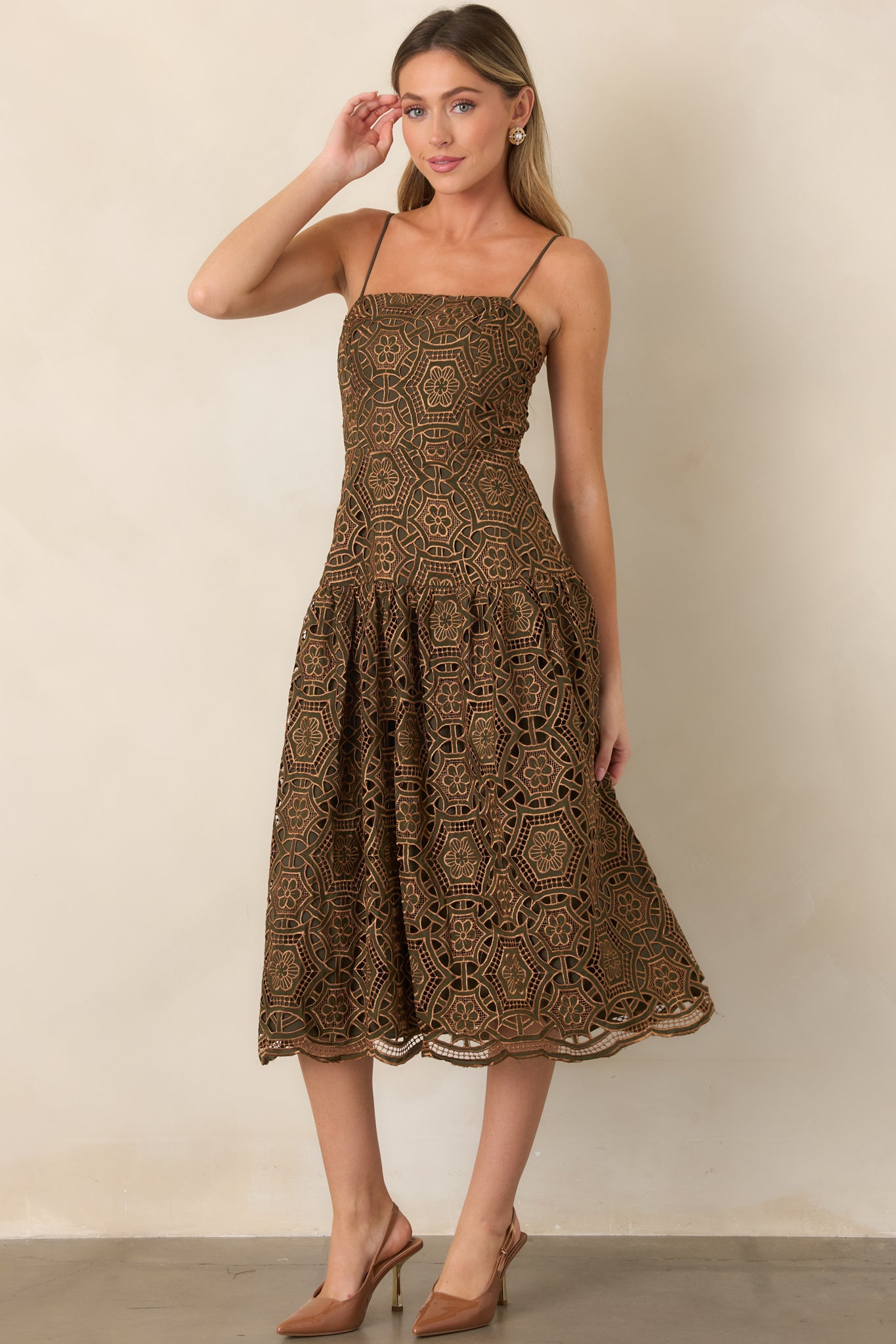 Olive-lined midi dress featuring an intricate gold metallic lace overlay, fitted bodice, straight neckline, and adjustable spaghetti straps.