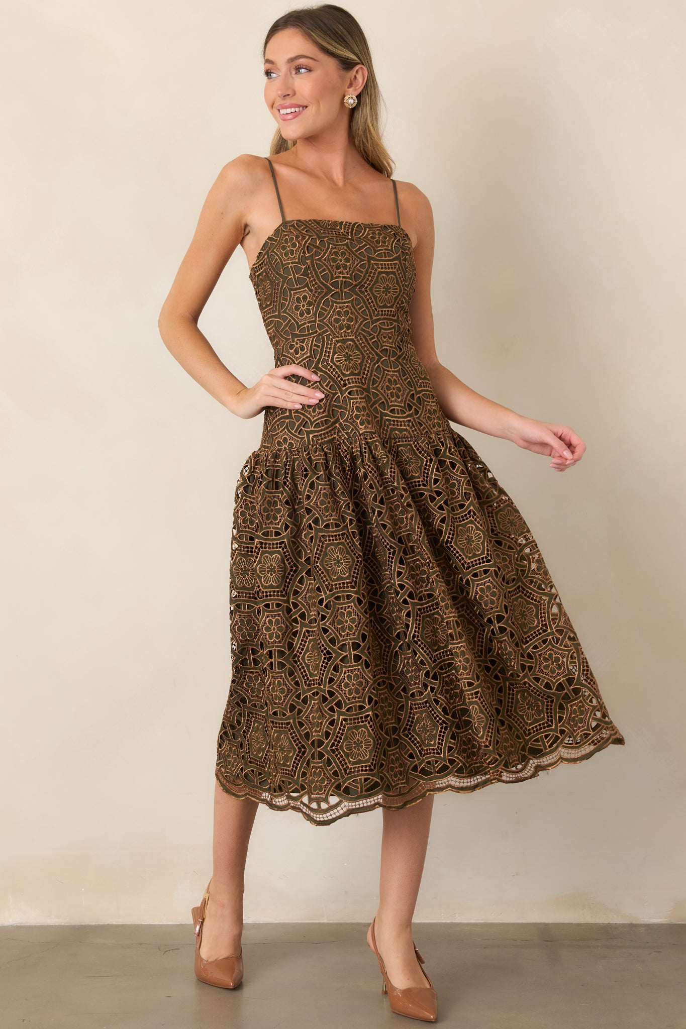 Elegant lace midi dress showcasing a sleek straight neckline, slender adjustable straps, and a softly voluminous skirt.