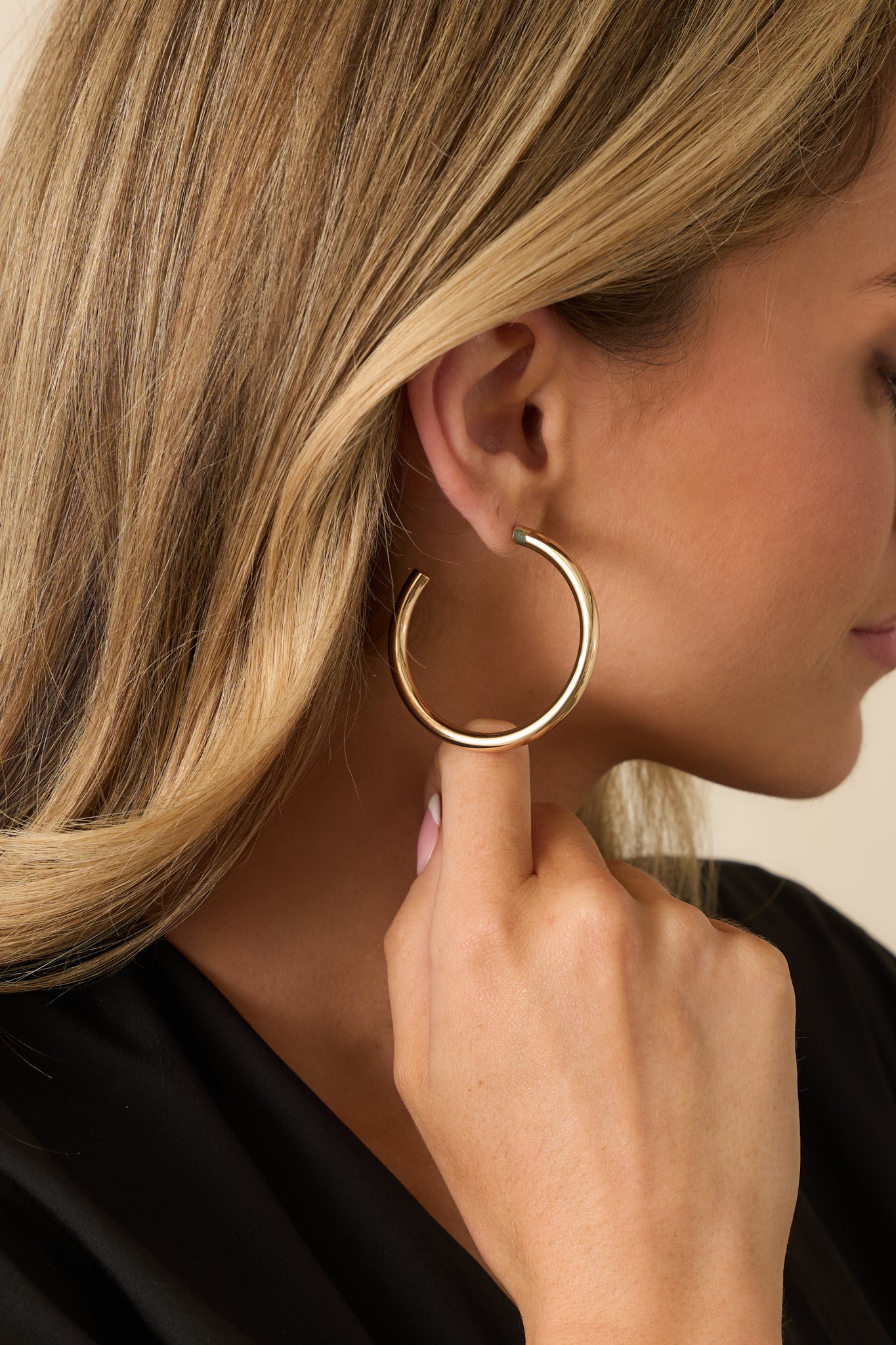 Gold open-hoop earrings with a slightly thickened shape and smooth polished finish shown from the front.