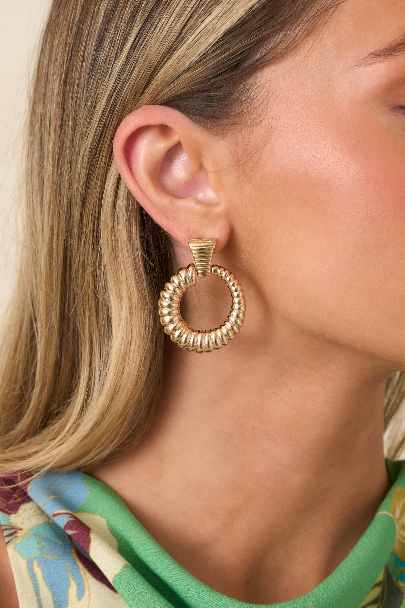 Earrings featuring a ribbed stud with a connected ribbed hoop.