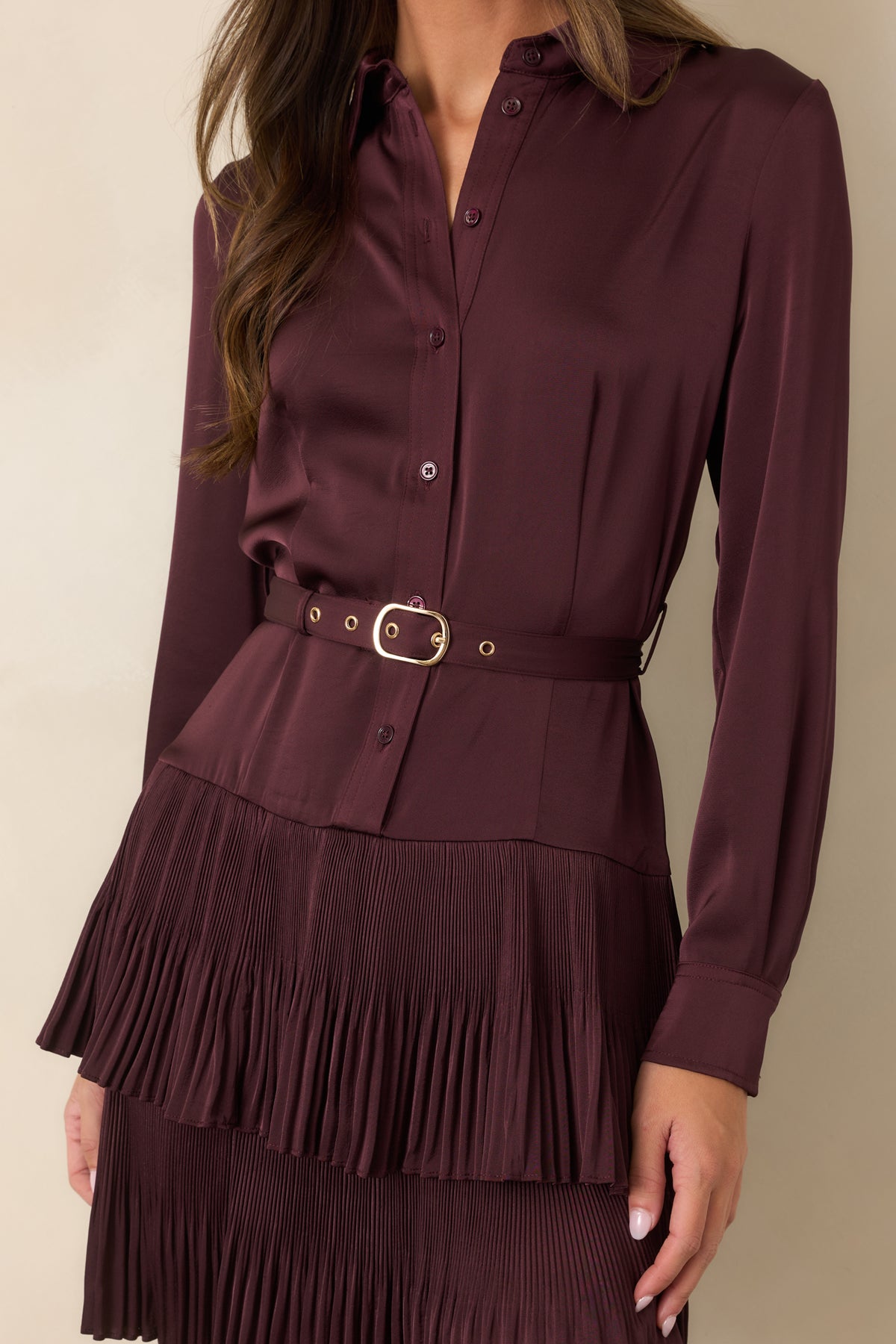 Gold-tone belt buckle and coordinating eyelets add a polished accent to the rich plum dress.