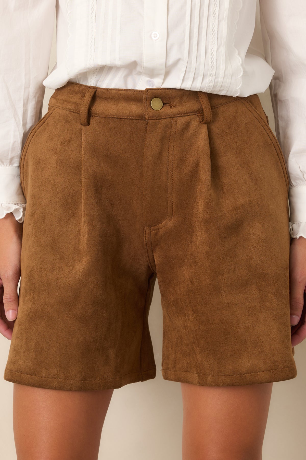 Close-up detail highlighting the gold-tone button, belt loops, and concealed zip fly.