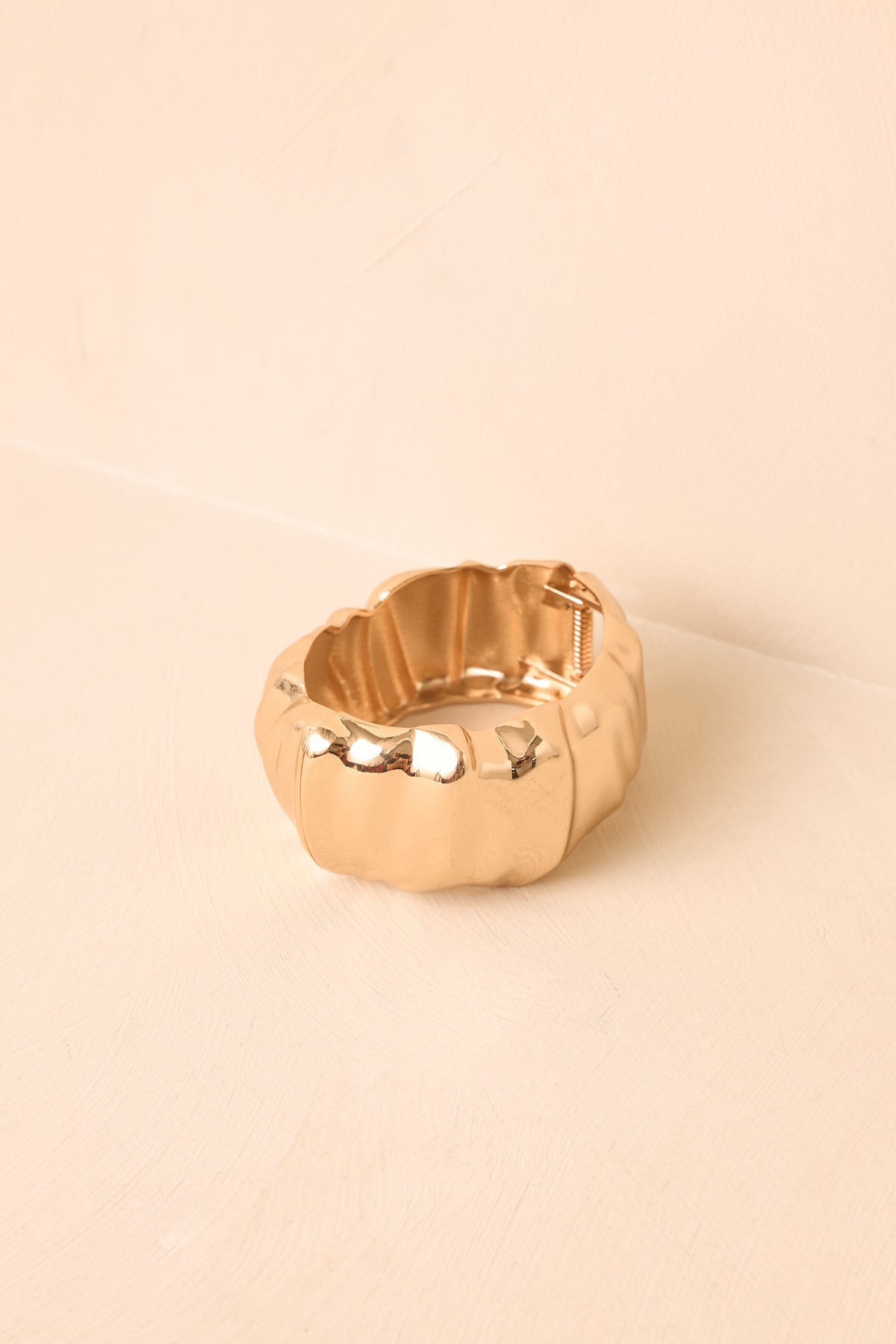 Gold-tone cuff bracelet presents a refined polished finish and structured shape designed to make a statement.