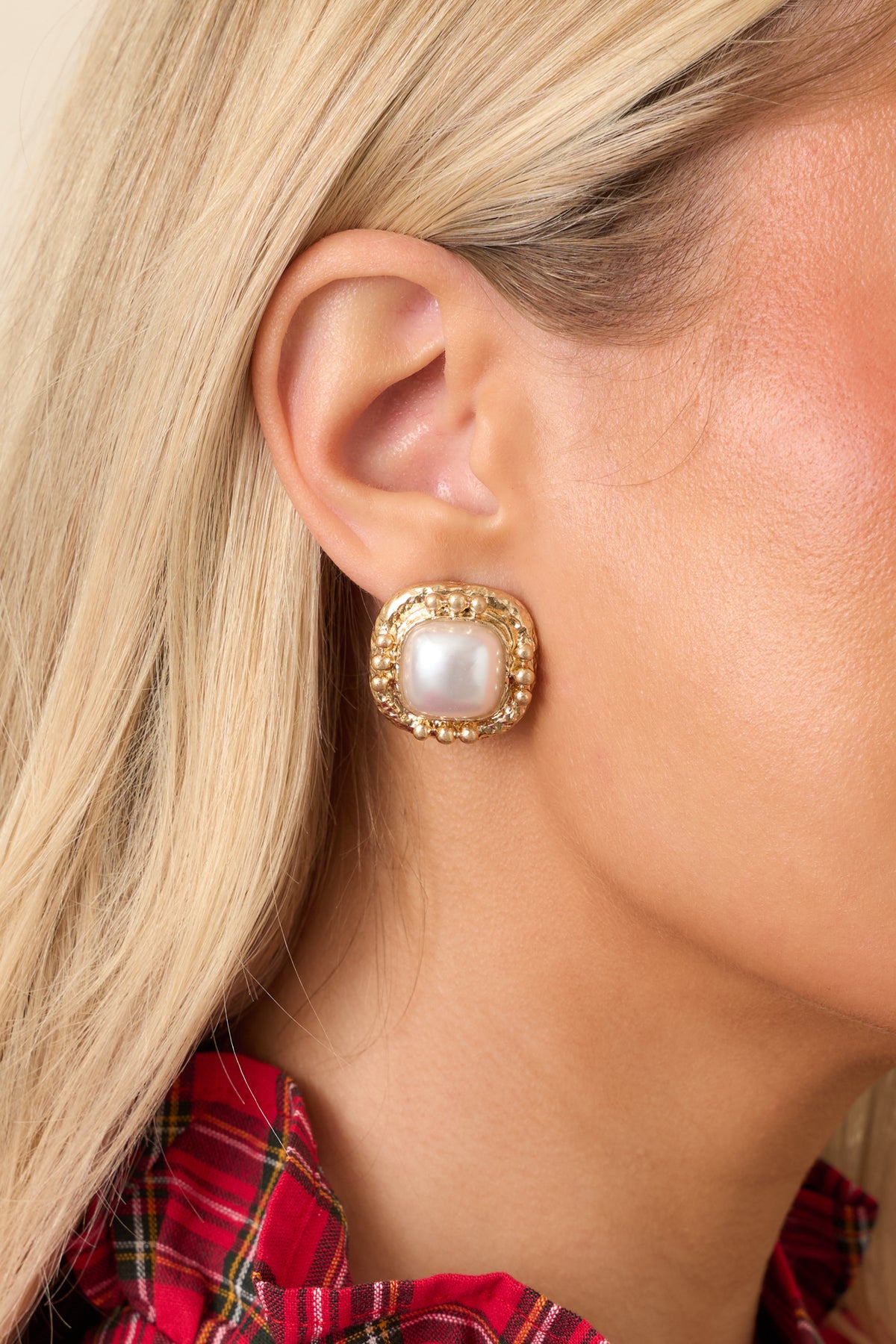 Gold-tone statement earrings featuring luminous cushion-shaped pearl centers and textured frames with beaded borders.