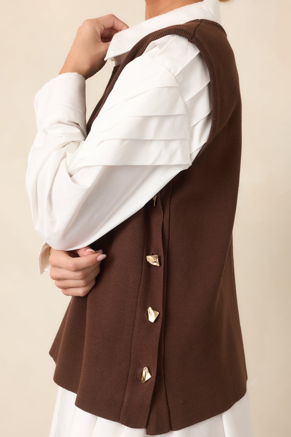 Gold-tone functional side buttons add a polished accent to the sweater knit top.