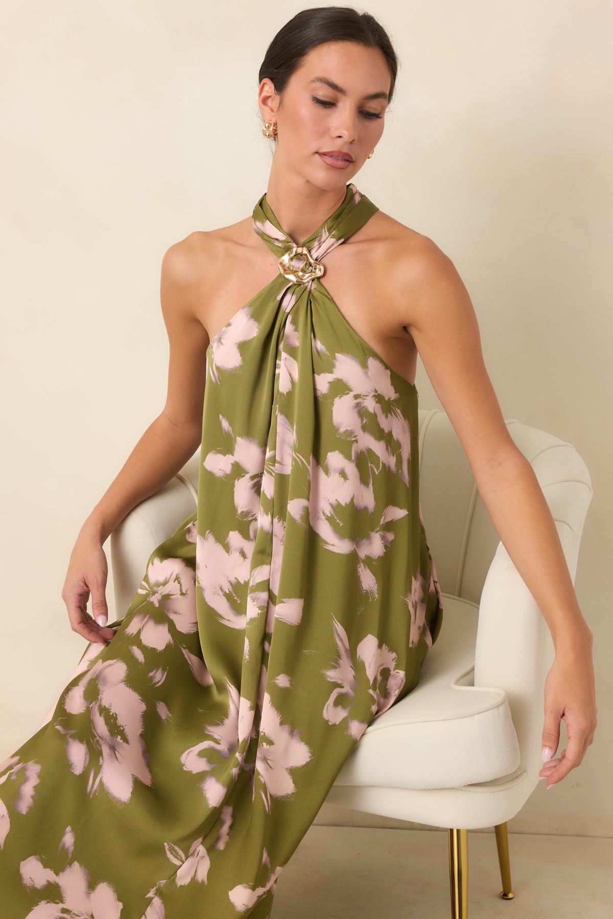 Close-up highlighting the jewelry-inspired gold-tone halter accent and soft folds beneath the neckline.
