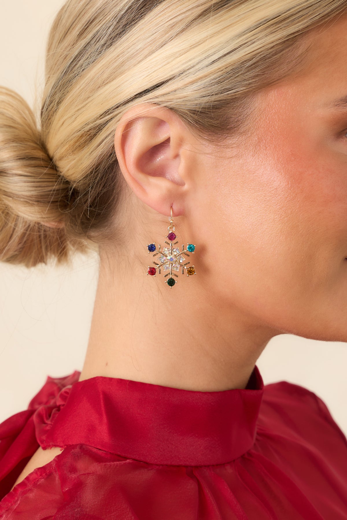 Gold-tone snowflake earrings featuring pink, blue, and turquoise stones.