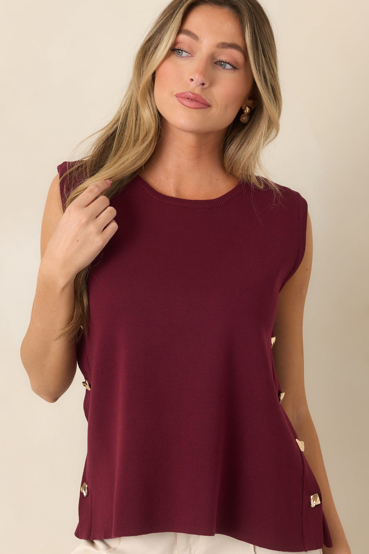 Detailed view of the top showcasing the functional gold-tone buttons arranged vertically along the side seam.
