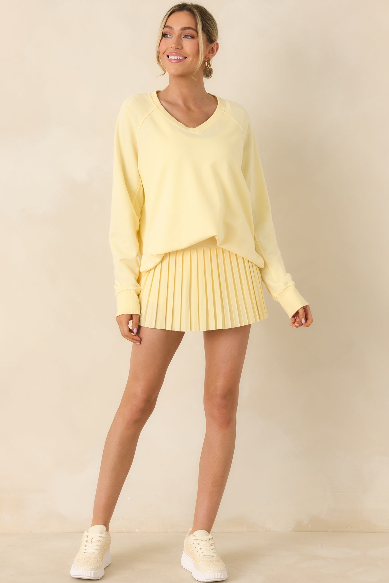 Golden yellow sweatshirt featuring a flattering v-neck and effortless drape.