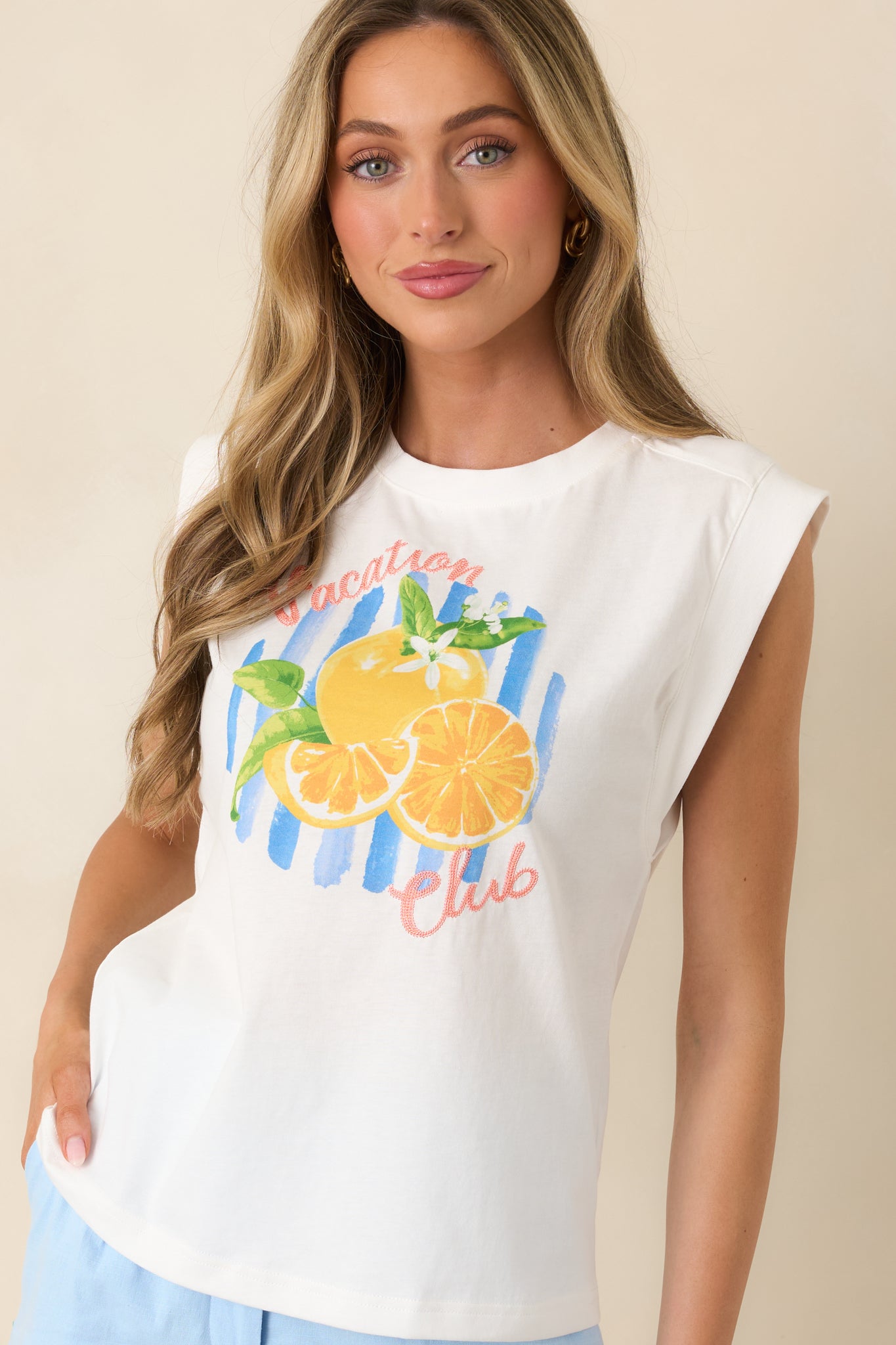 Graphic and fabric texture close-up showing playful citrus design on sleeveless top.