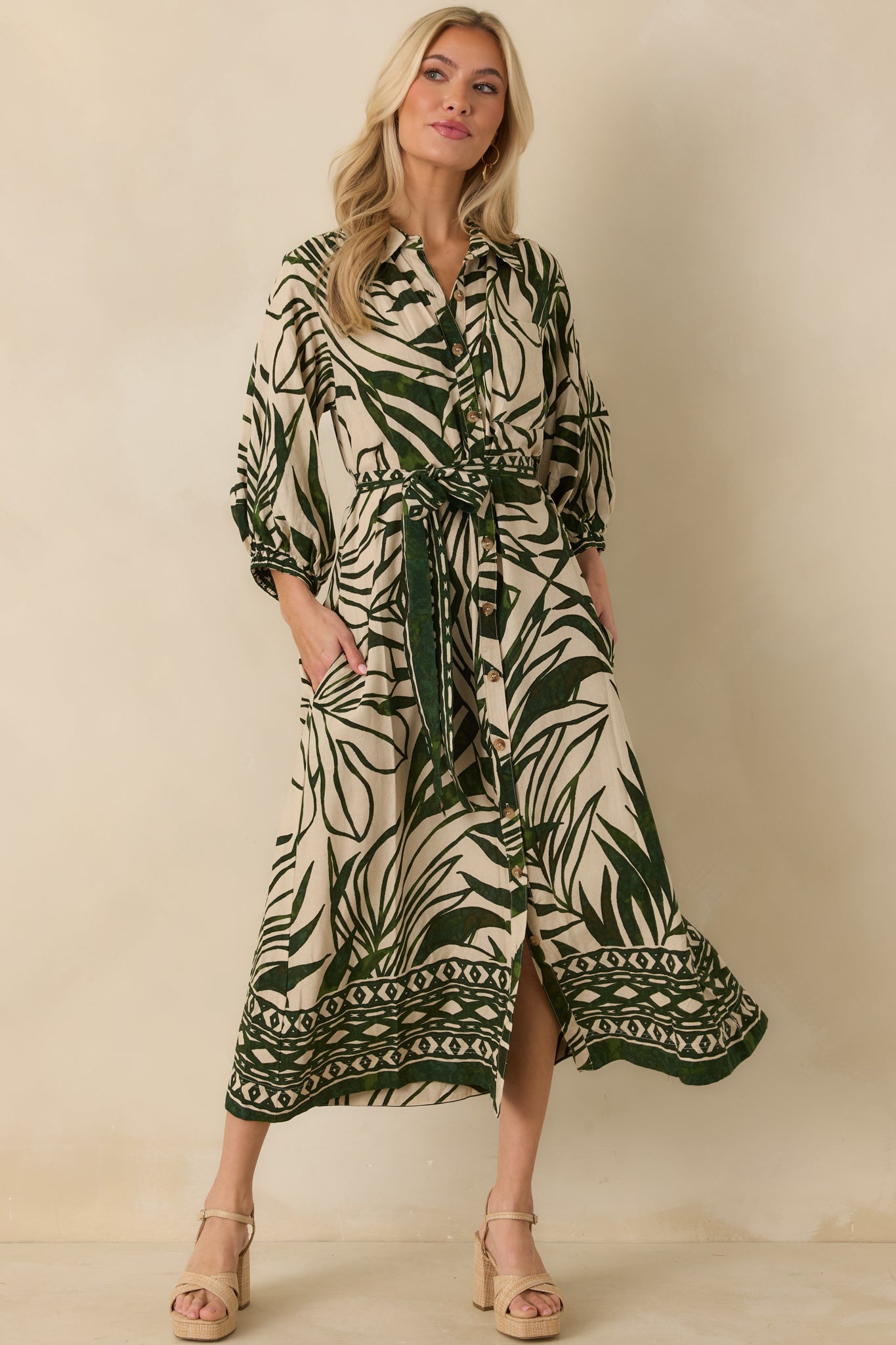 Green and beige tropical print maxi dress with collared neckline, functional button front, and 3/4 length sleeves.