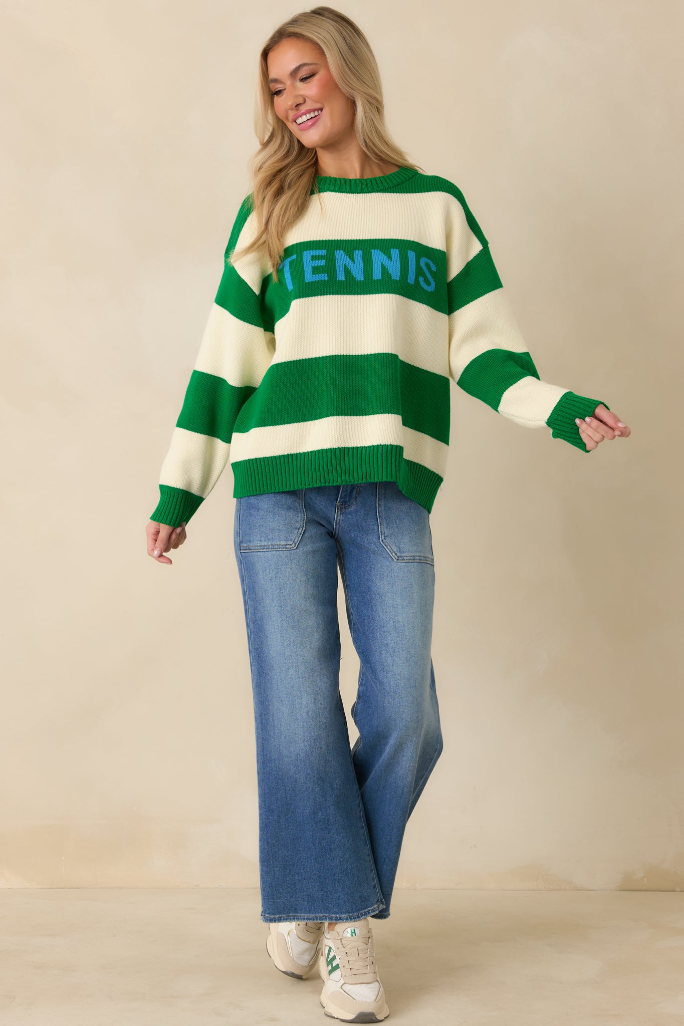Bold green and ivory striped knit sweater featuring contrast “TENNIS” lettering across the front.