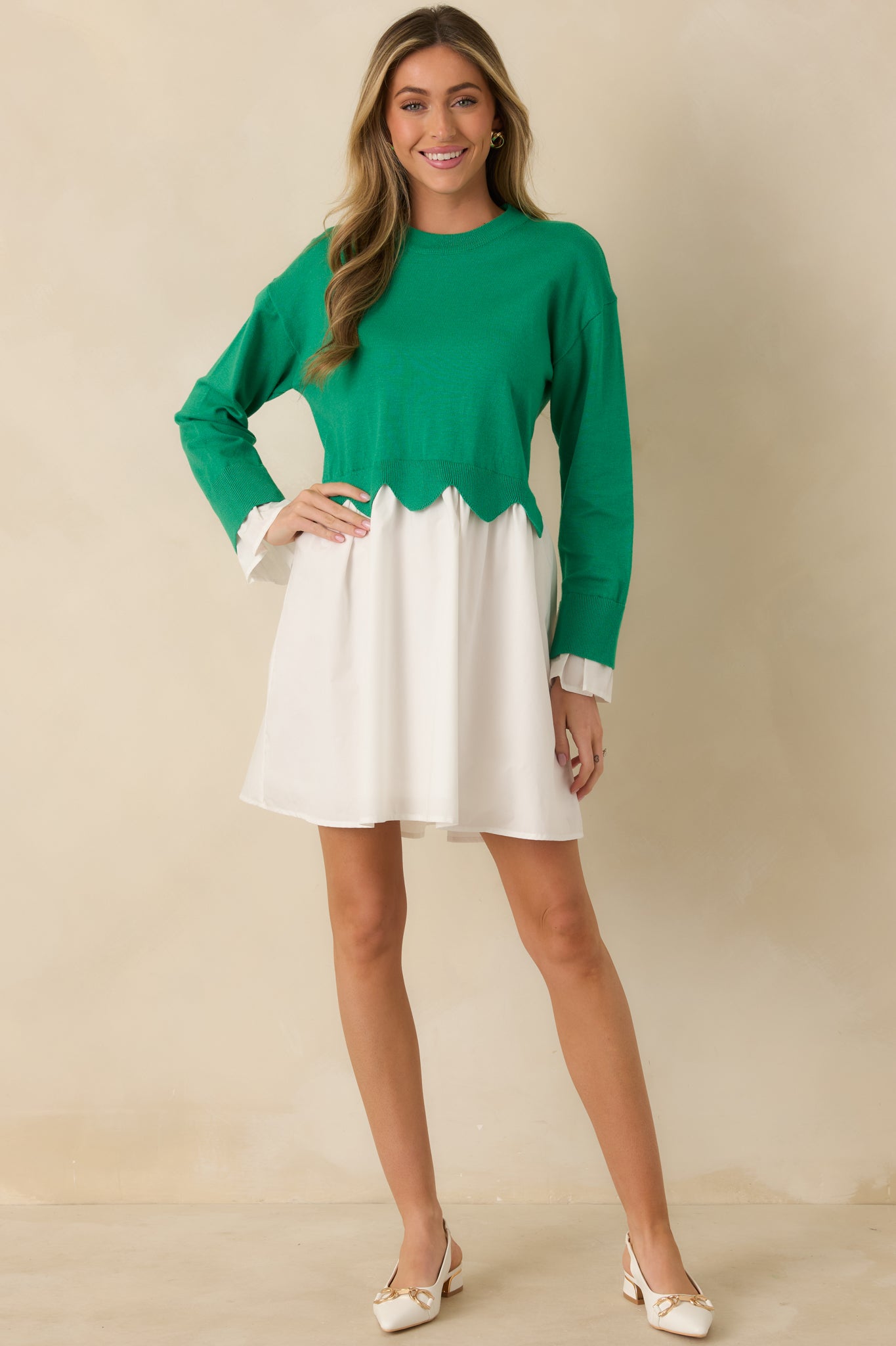 Green and white mini dress featuring a soft knit sweater bodice with long sleeves, round neckline, and a flowy woven skirt.