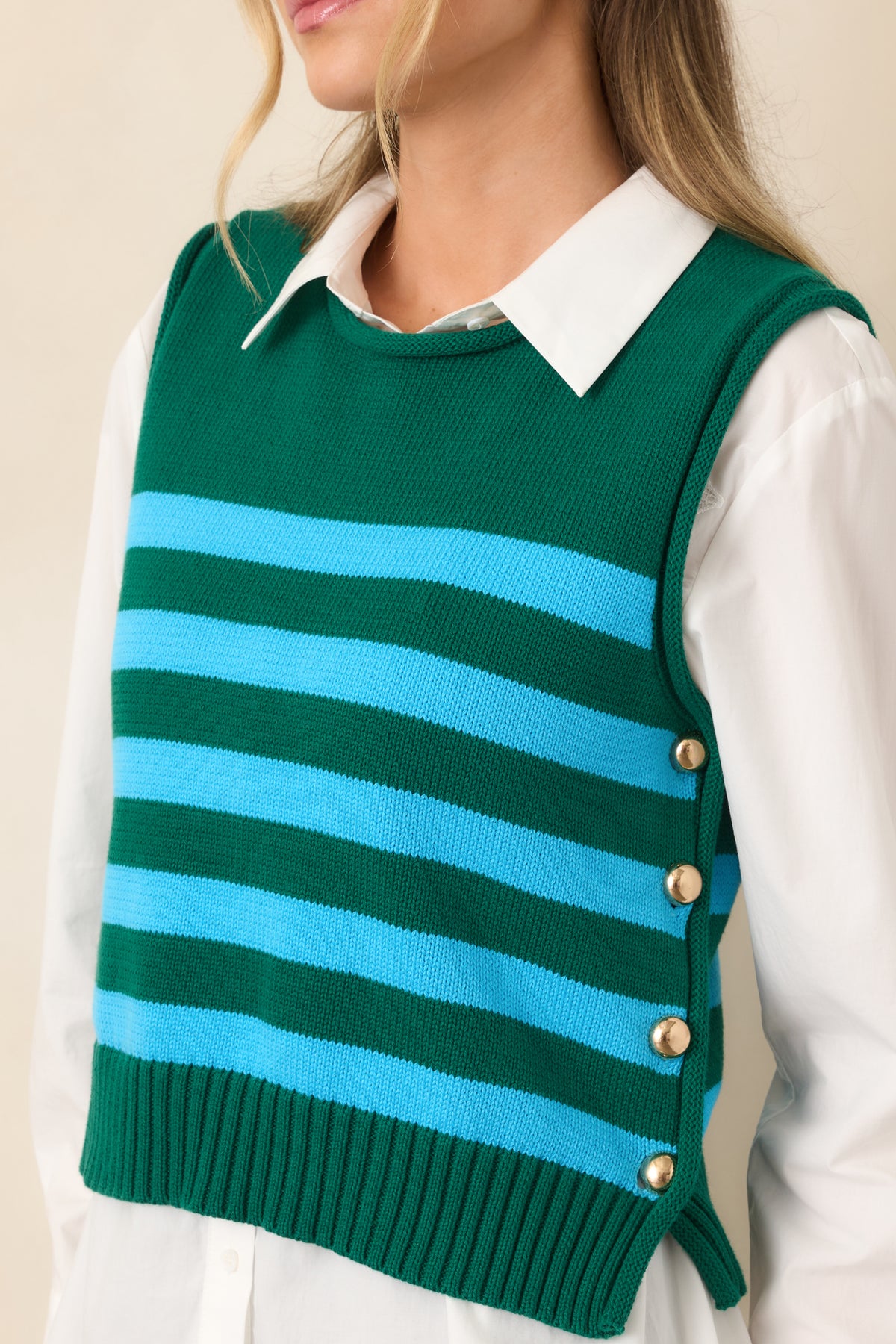 Close-up of the green and aqua cotton stripes highlighting the ribbed texture and polished gold-tone button accents along the side.