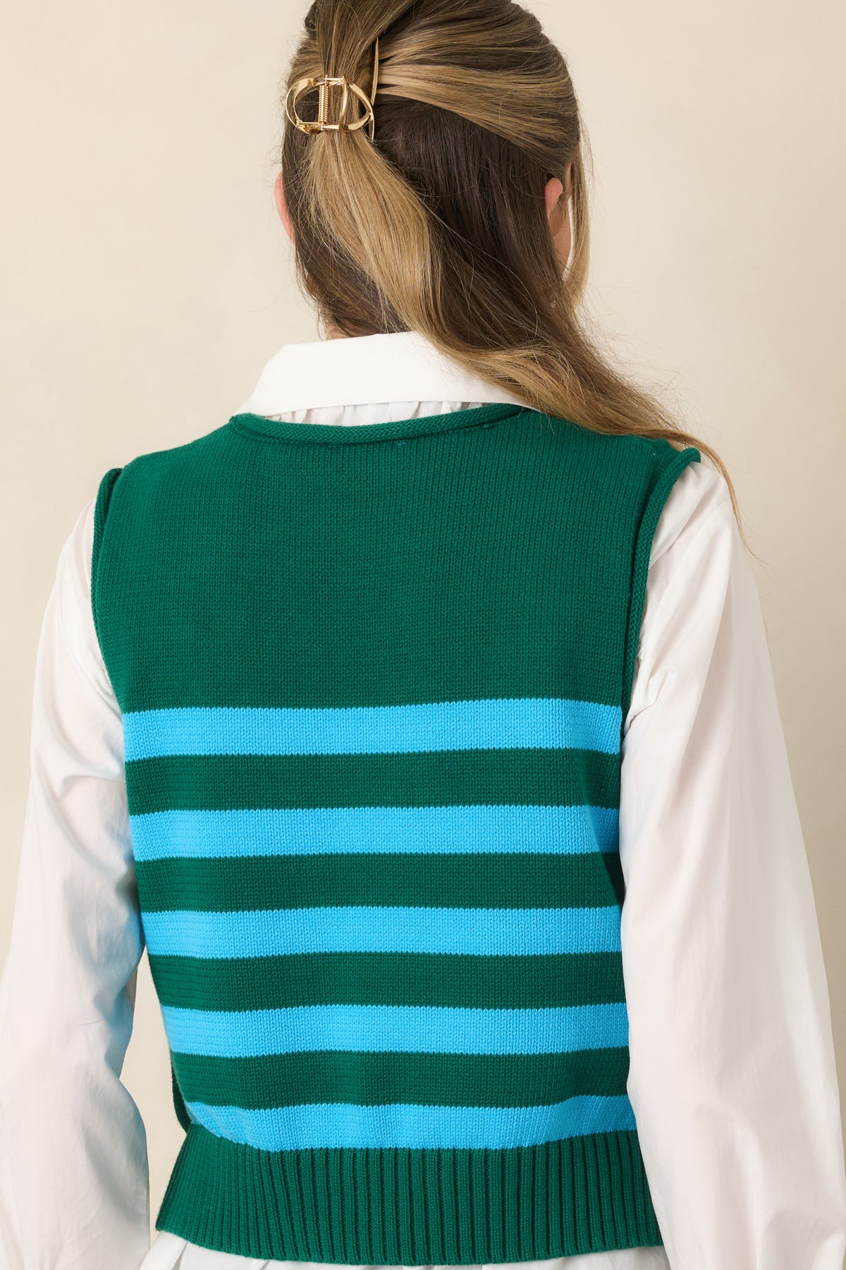 Rear view of the green and aqua striped cotton top showcasing its relaxed boxy silhouette, round ribbed neckline, horizontal stripe pattern, and ribbed hem.