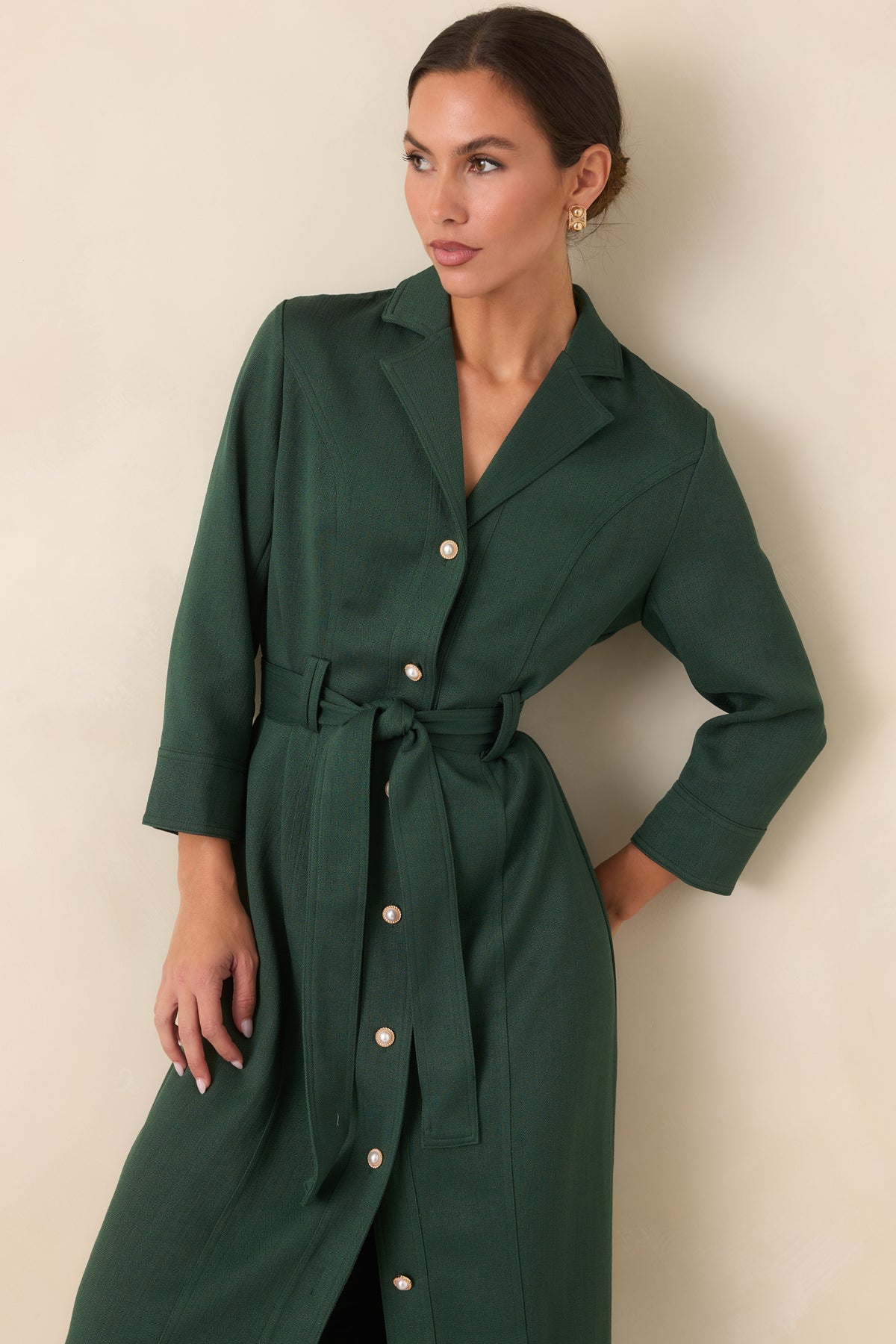 Green dress detail featuring the wide stitched band around the bracelet-length cuff.