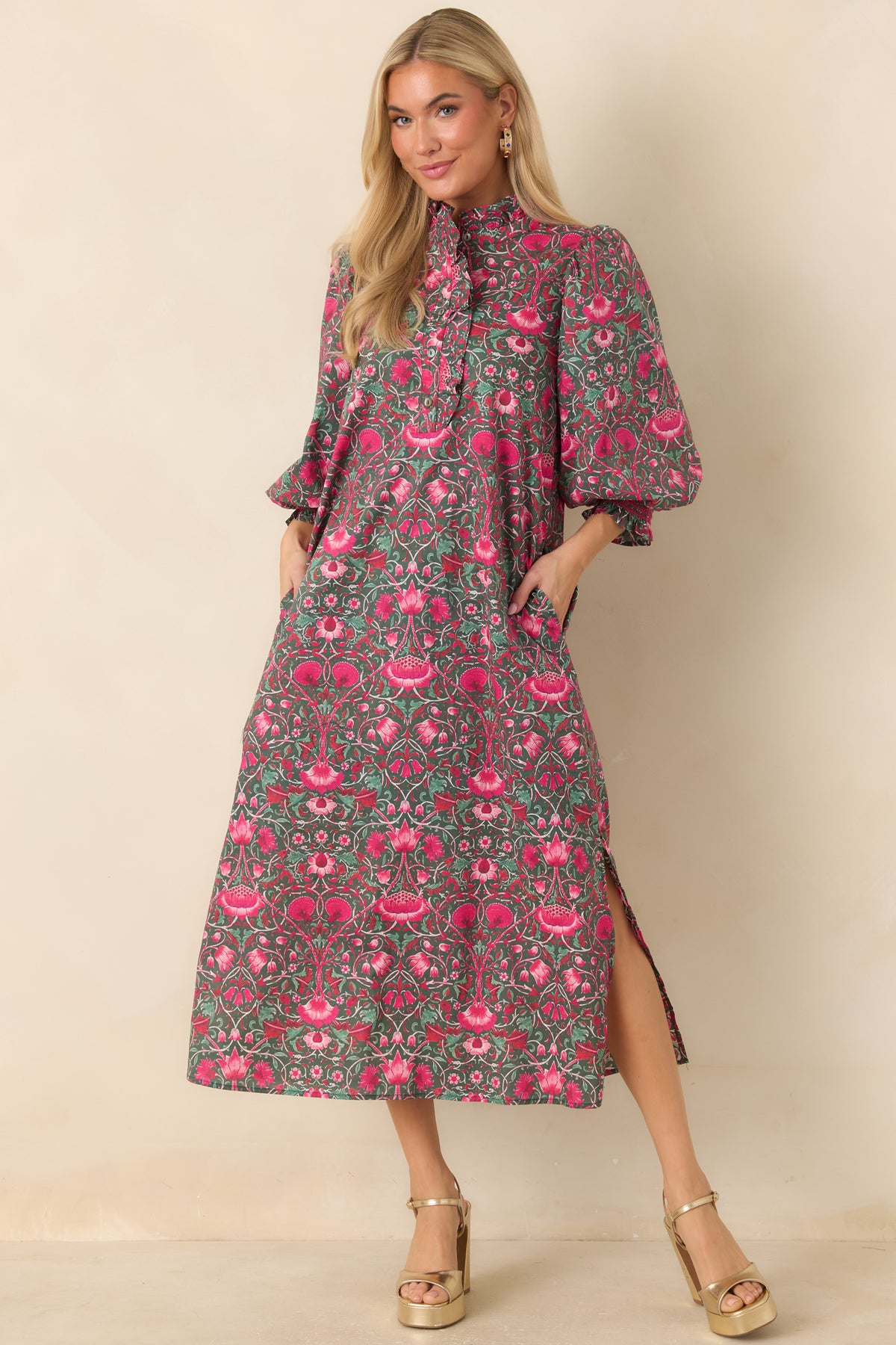 Cotton midi dress featuring vibrant pink flowers and winding vines against a deep green background.
