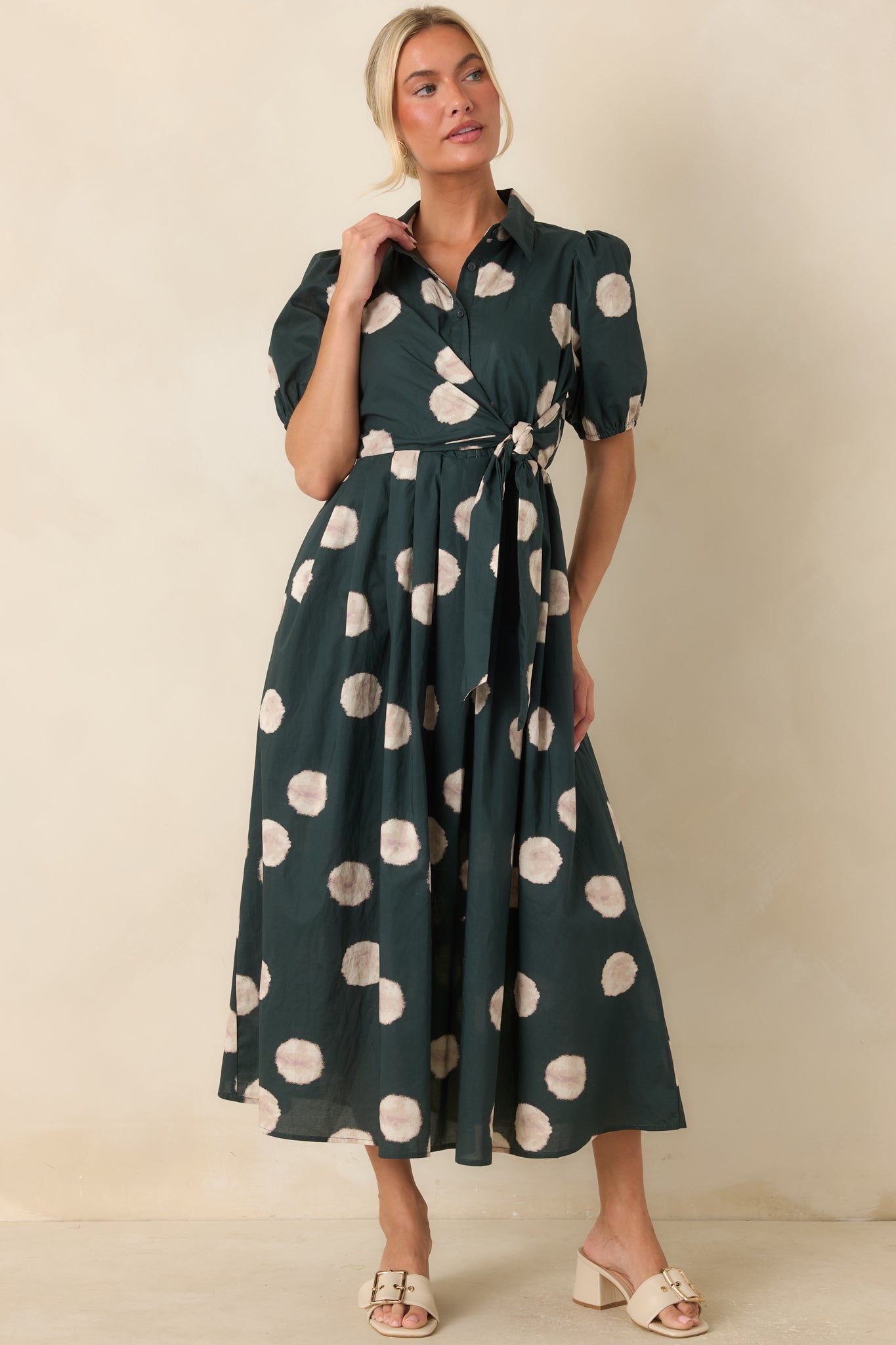 Green cotton midi dress featuring a softly gathered waist, short puff sleeves, and a classic silhouette enhanced by a wrap-inspired side tie.