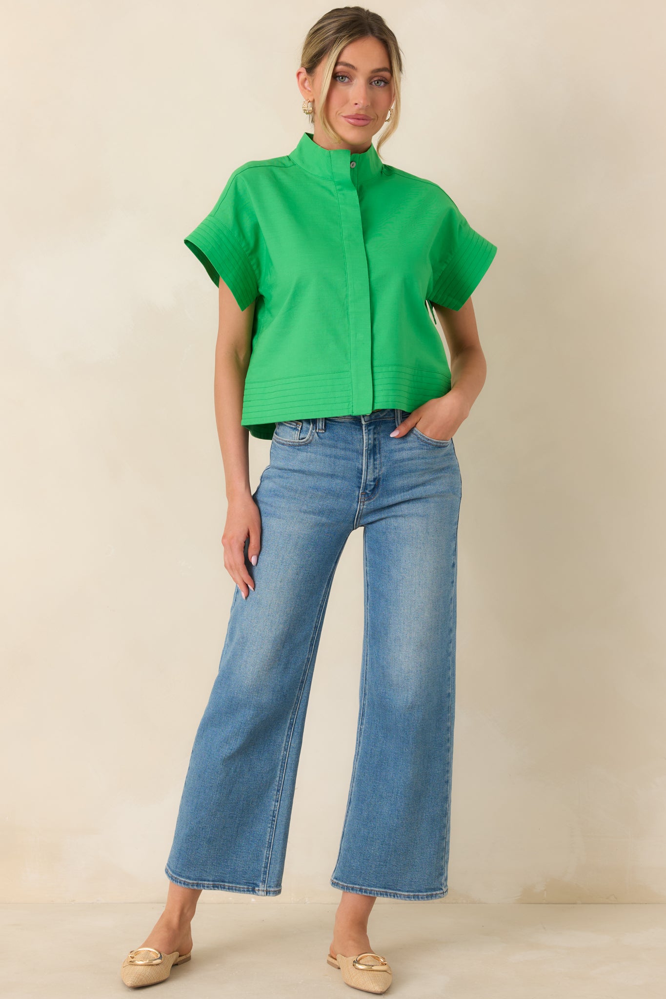 Green cotton-linen blend top with a boxy silhouette, short cuffed sleeves, and polished mock neckline.