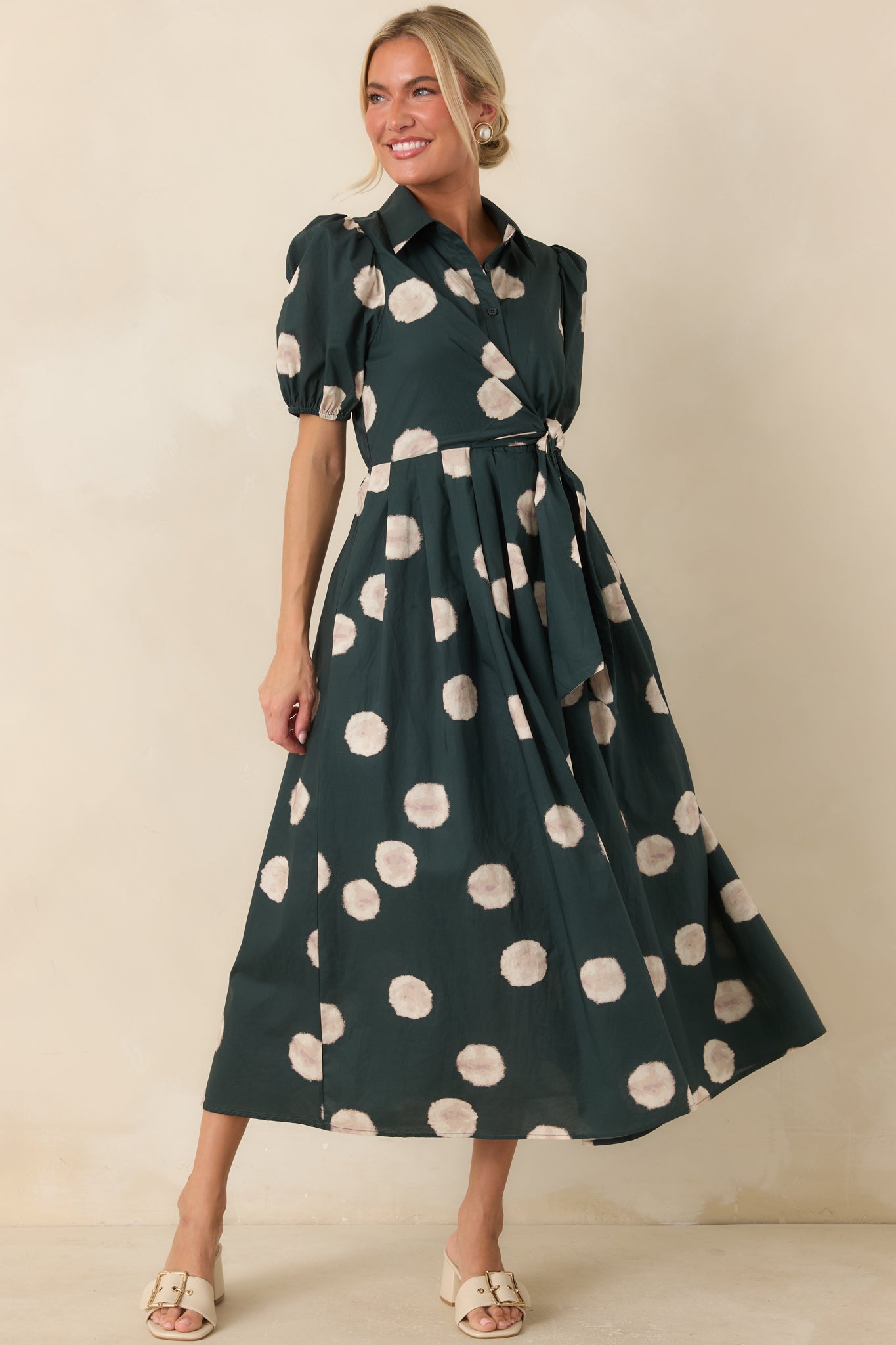 Green dot print midi dress with a defined waist, soft rayon lining, and timeless tailoring suited for everyday wear.