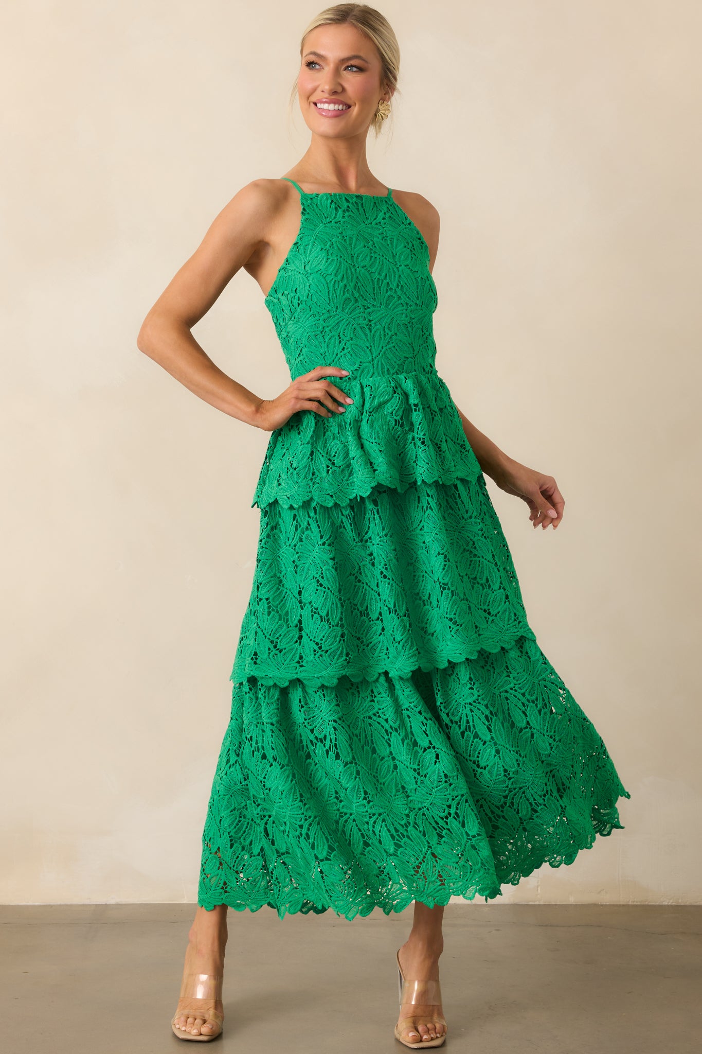 Green dress in motion, showcasing the tiered skirt and delicate embroidered overlay in a front-facing pose.