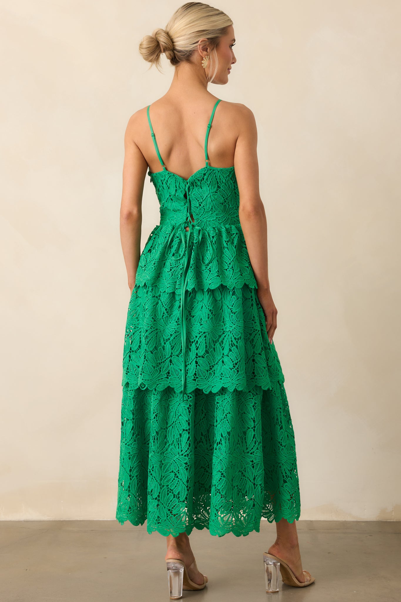 View from behind of the green dress showing the adjustable self-tie corset lace-up and spaghetti straps.