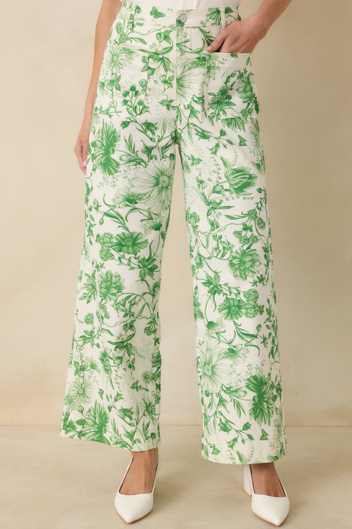 Green floral print cotton pants with high-rise waist, straight leg shape, and pull-on comfort.