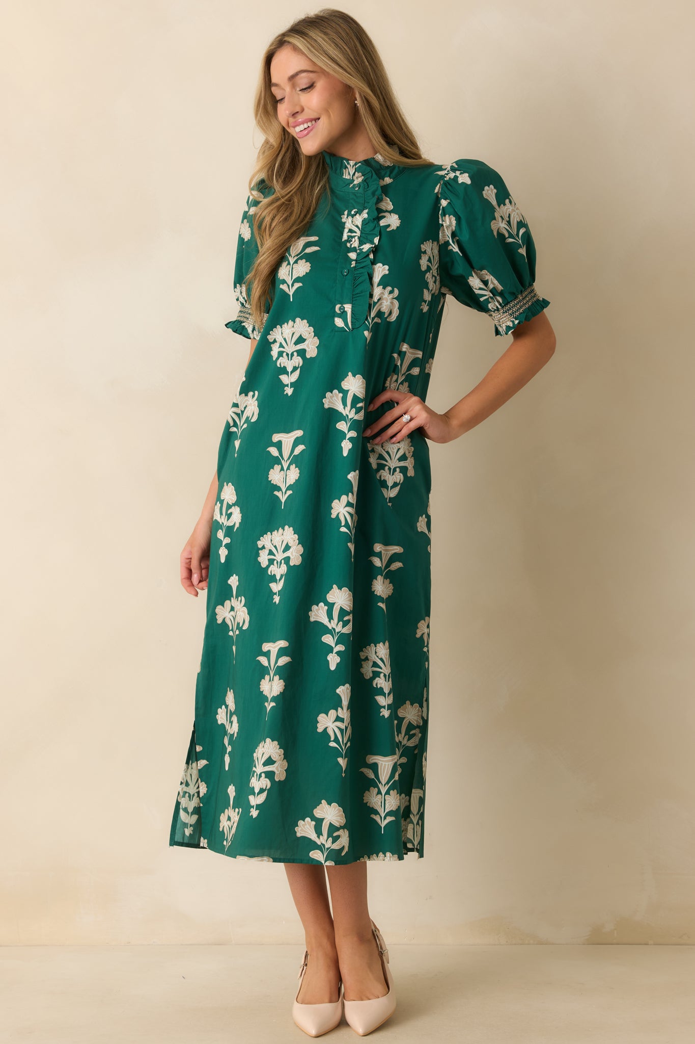 Flowy green floral dress featuring short smocked puff sleeves and a ruffle-trimmed button front design.