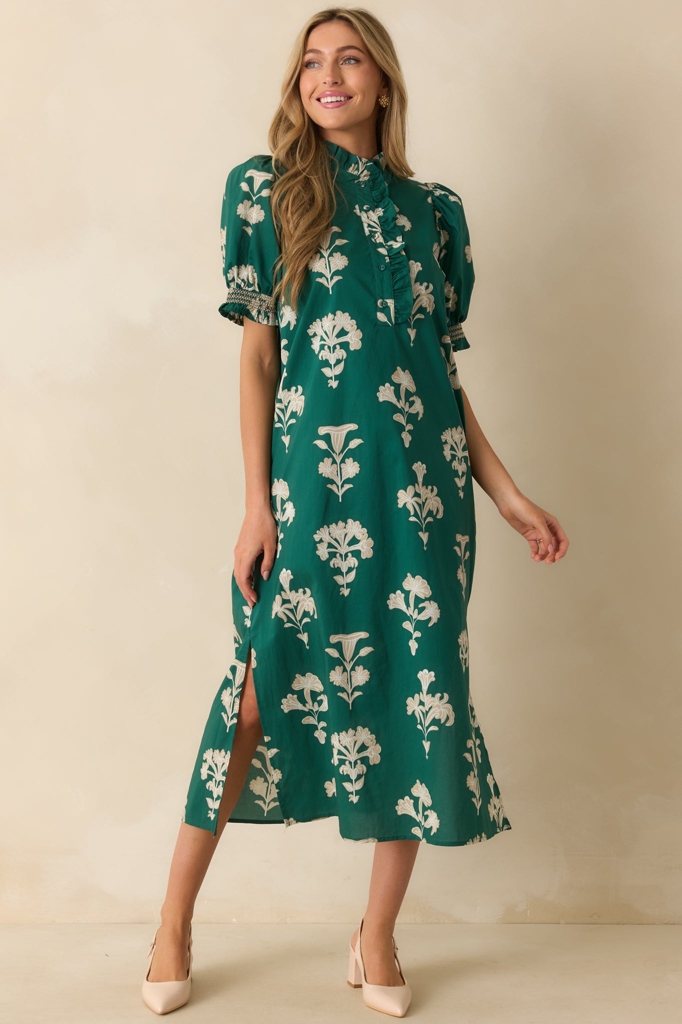 Green floral dress highlighting the tiered ruffle neckline and delicate button placket down the front.