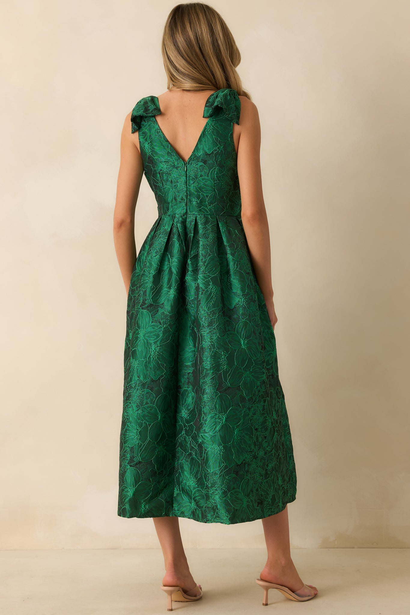 Rear view of green floral midi dress showing discreet back zipper, self-tie straps, and sleeveless design.
