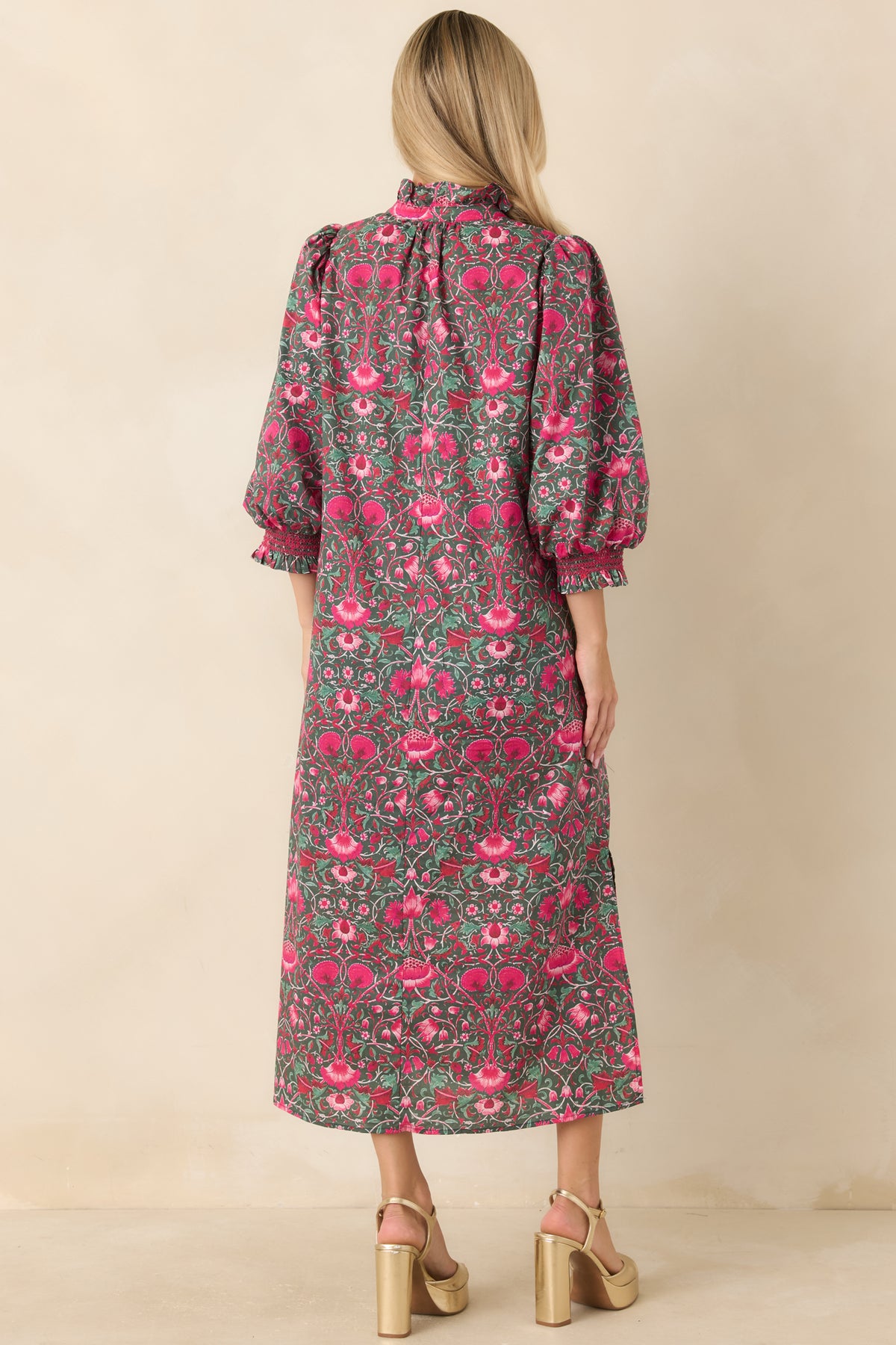 Back of the green floral midi dress featuring a straight silhouette and three-quarter puff sleeves.