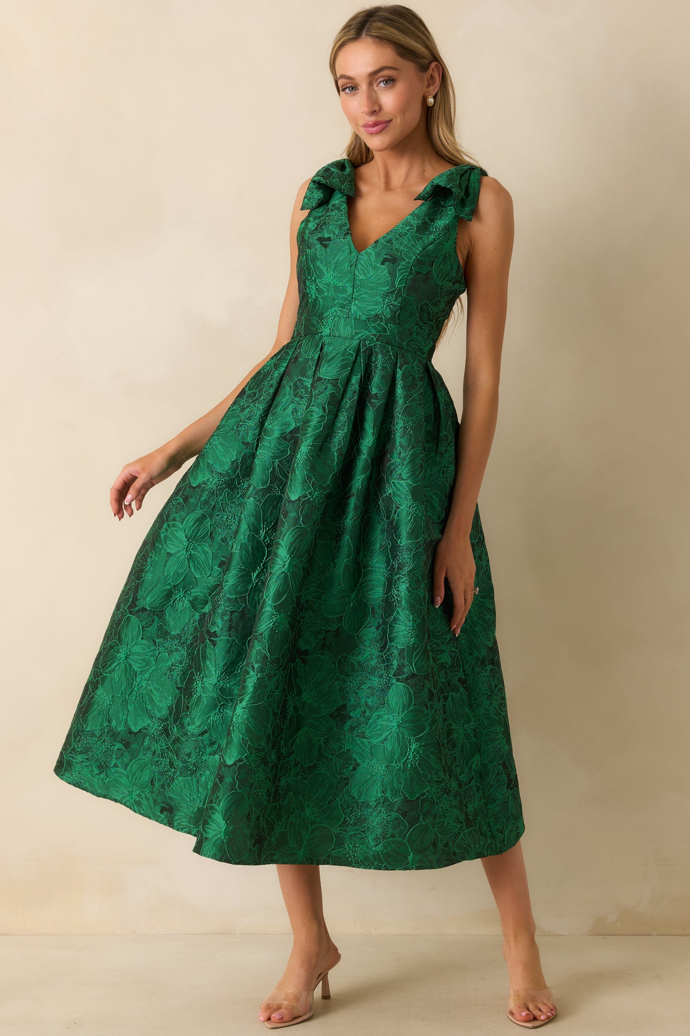 Sleeveless green floral midi dress featuring v-neckline, self-tie straps, and relaxed A-line silhouette.
