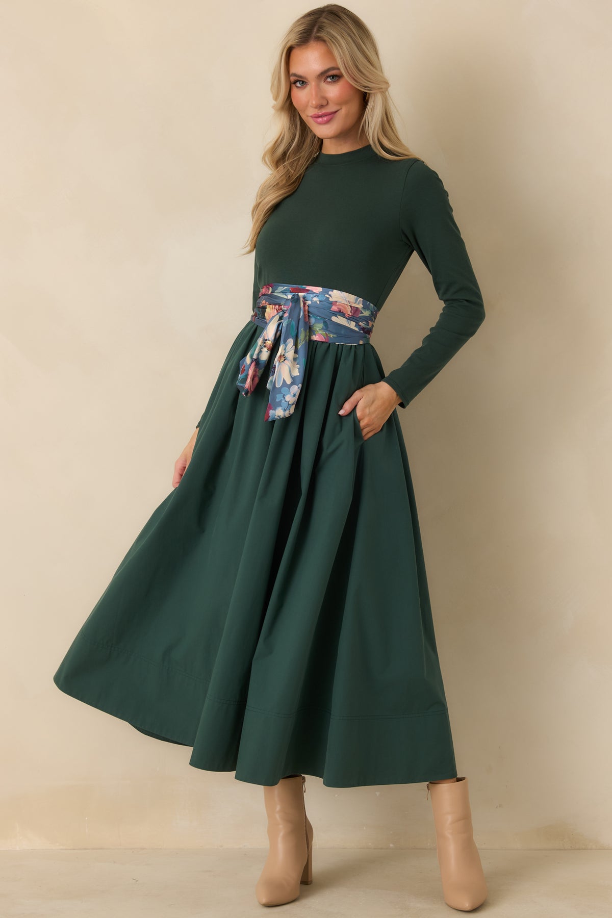 Green midi dress featuring a fitted long sleeve bodice and generously gathered cotton skirt with fluid movement through the hem.