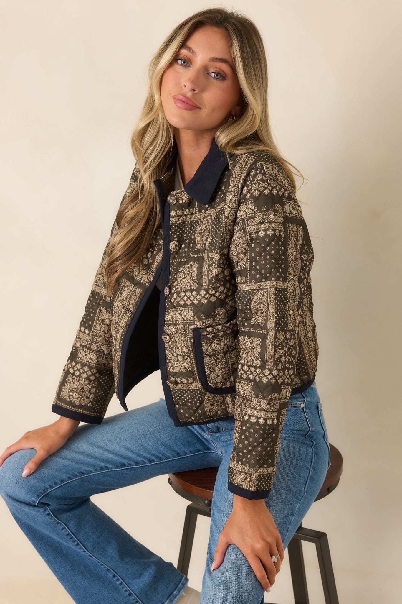 Green and ivory patchwork jacket showcasing long sleeves, front patch pockets, contrasting trim, and a polished cropped fit.