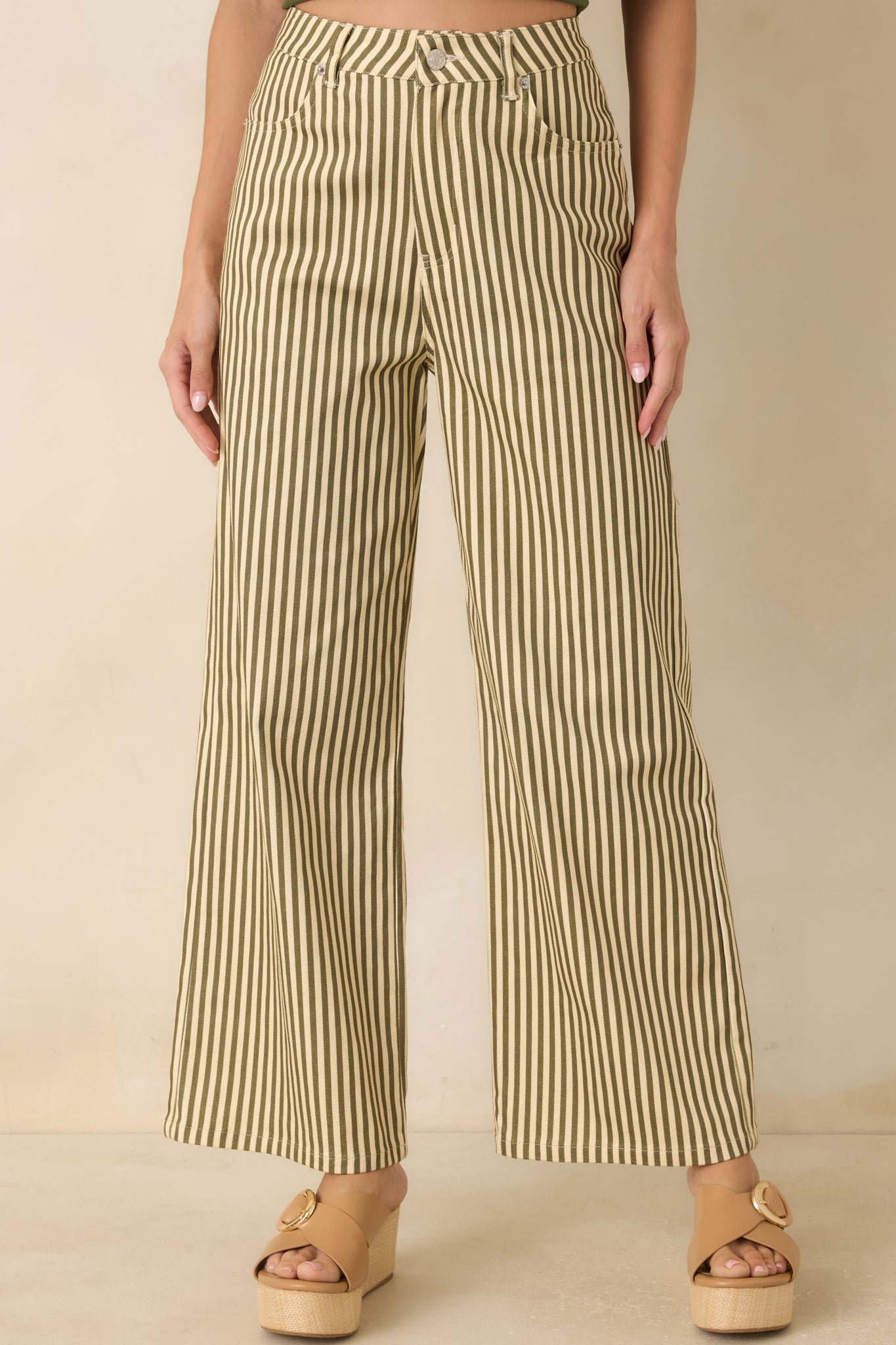 Detailed look at the green and ivory striped fabric showcasing the wide-leg construction and smooth finish.