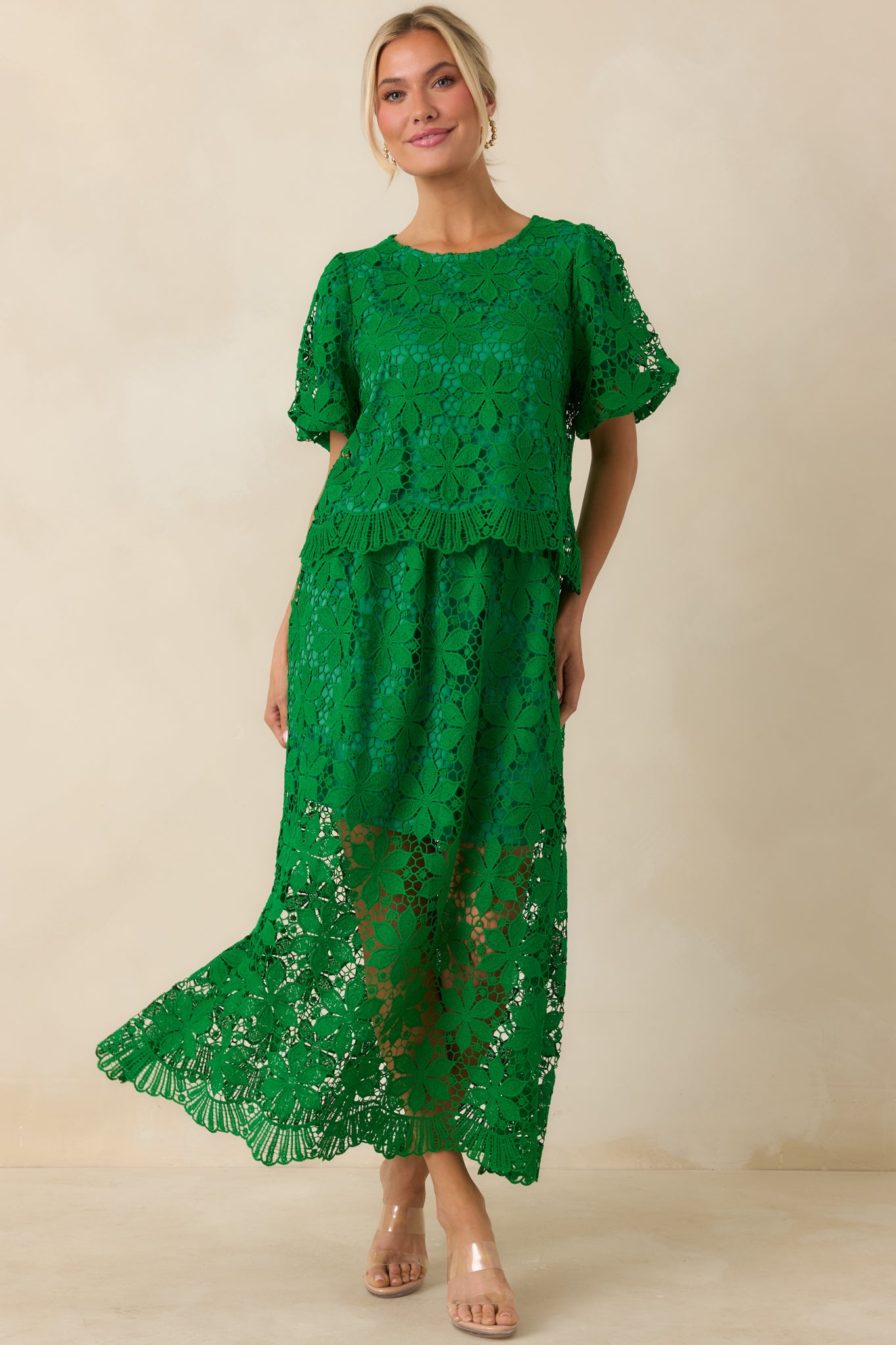 Green lace maxi skirt with floral crochet overlay and scalloped hem detail.