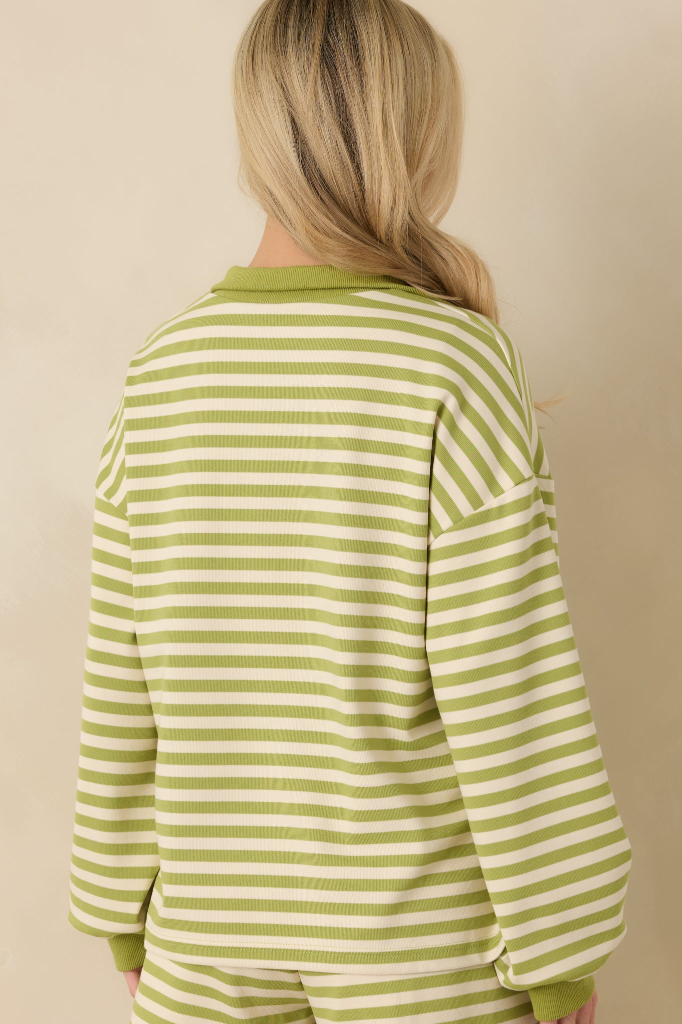 Green striped lounge top displaying the relaxed silhouette from the rear with a smooth knit finish and ribbed hem.