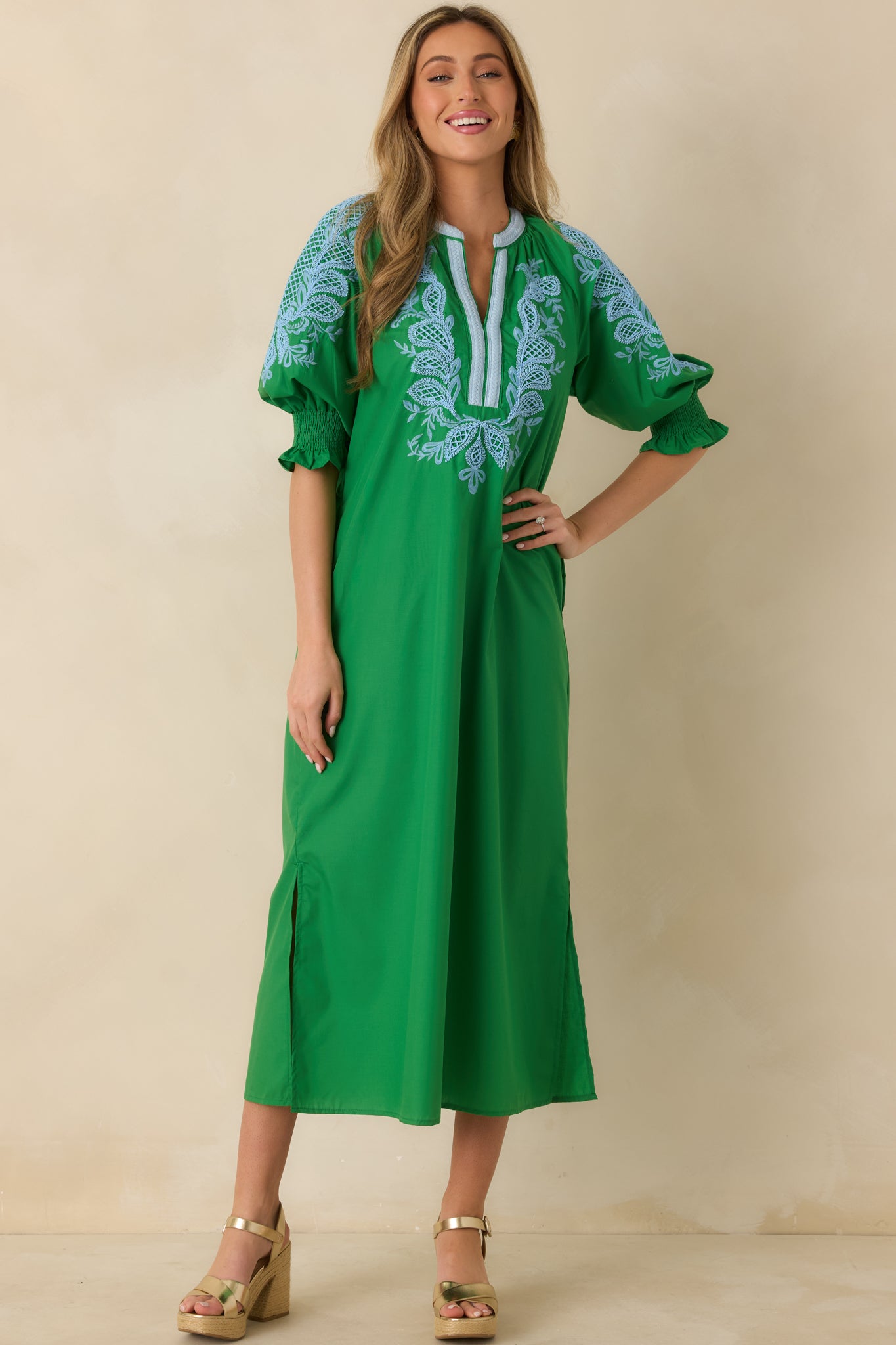Green maxi dress shown from the front emphasizing elbow-length puff sleeves with smocked cuffs.