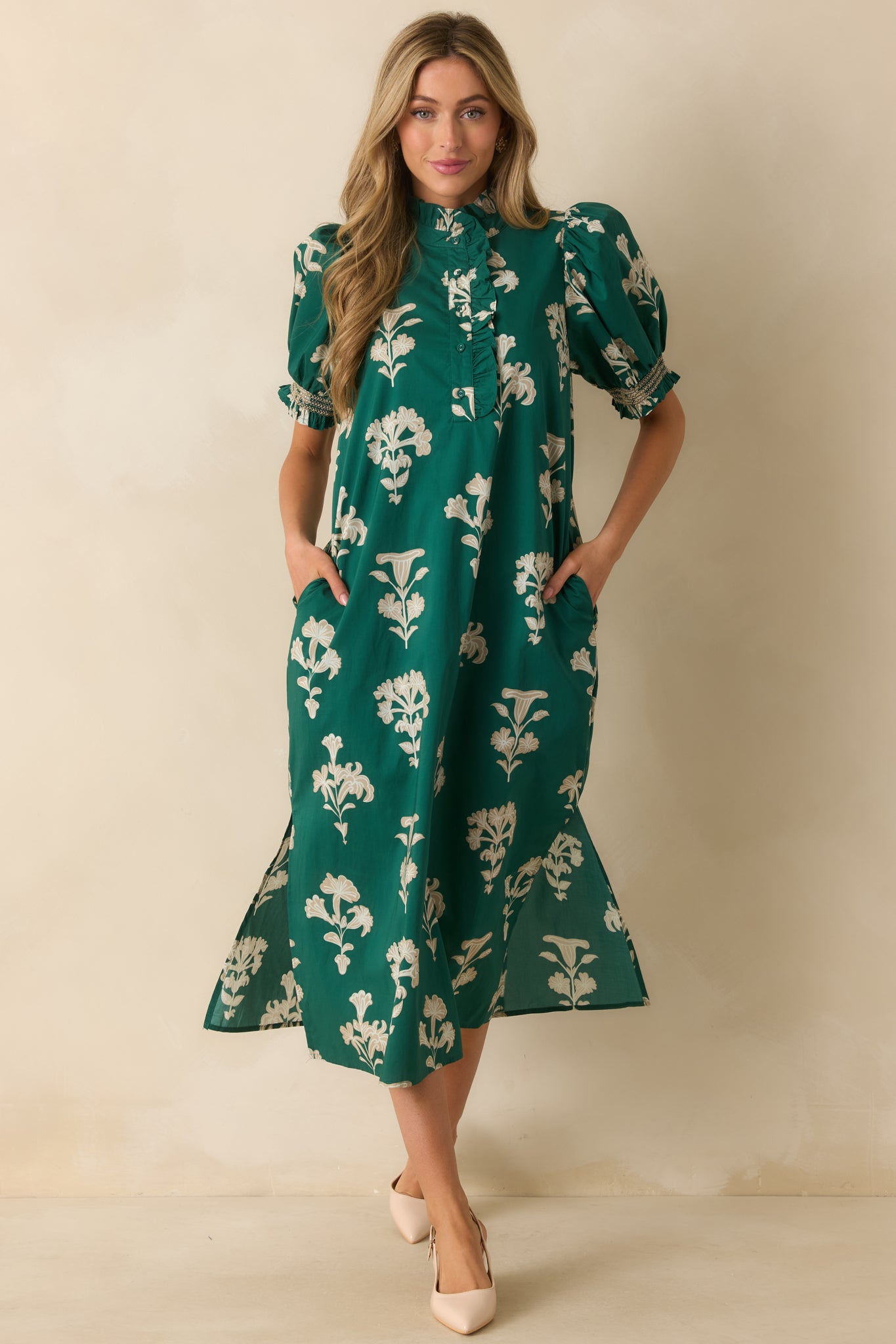 Elegant green maxi dress with functional pockets and subtle side slits along the hem.