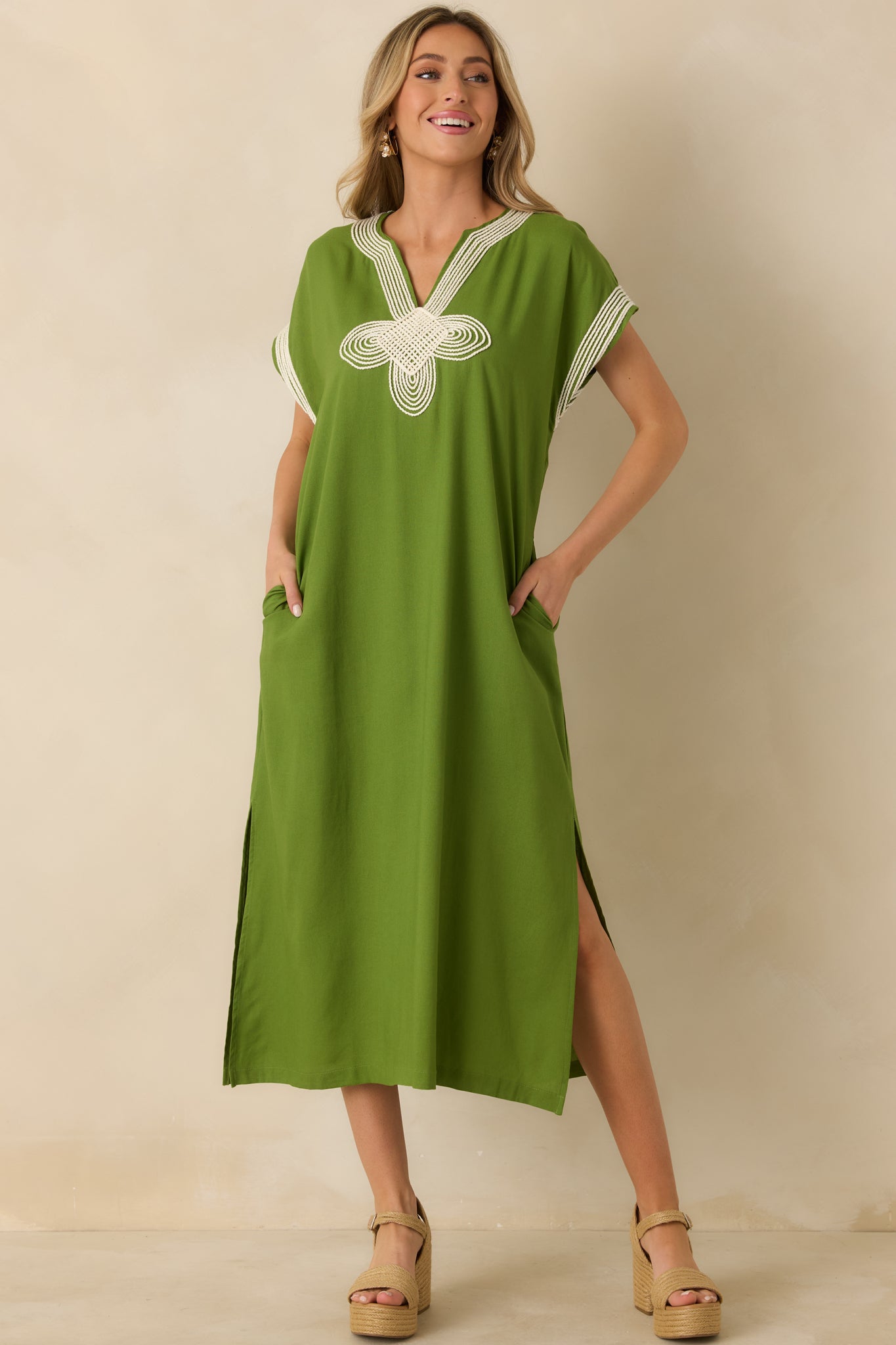 Green maxi dress with a straight silhouette, split V-neckline, and lightweight woven fabric for comfort.