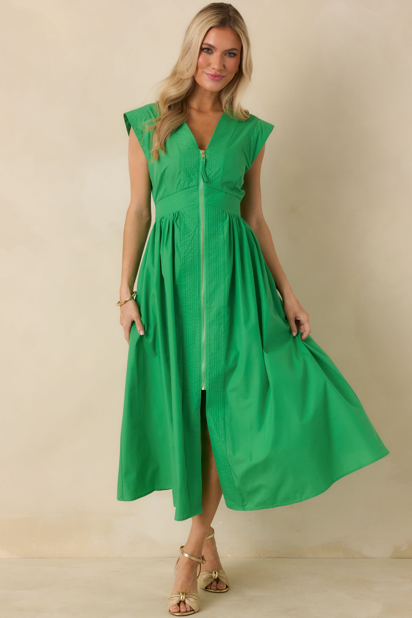 Front-facing view of green midi dress highlighting the structured woven fabric and clean silhouette.
