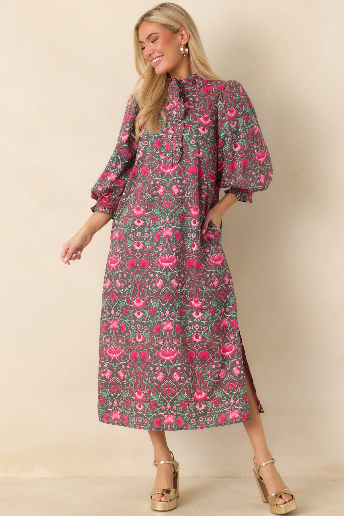 Relaxed green midi dress with a ruffled neckline and softly structured puff sleeves.