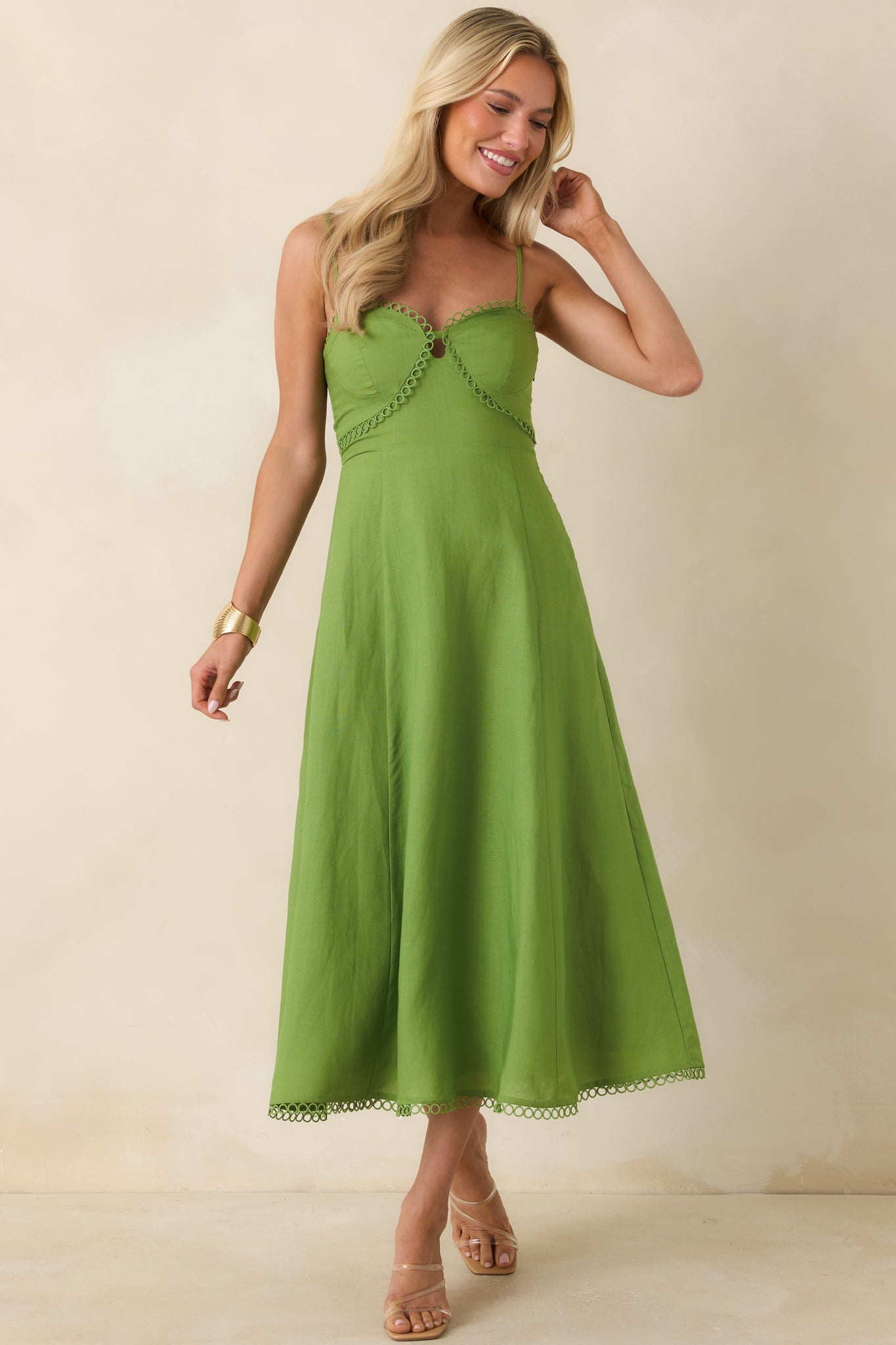 Green midi dress with a fitted structured bodice, adjustable straps, and a relaxed flowing silhouette.