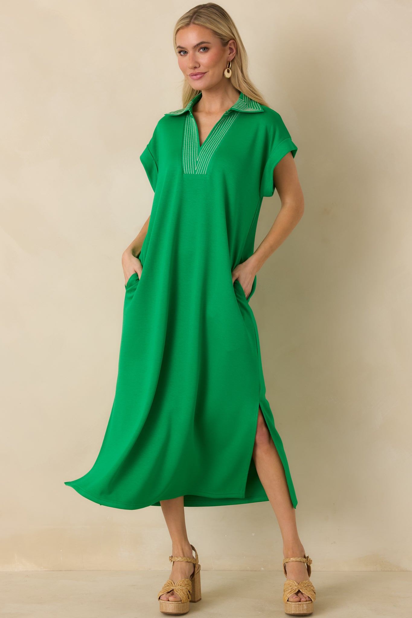 Green knit midi dress with relaxed straight silhouette and contrast stitched V-neckline.