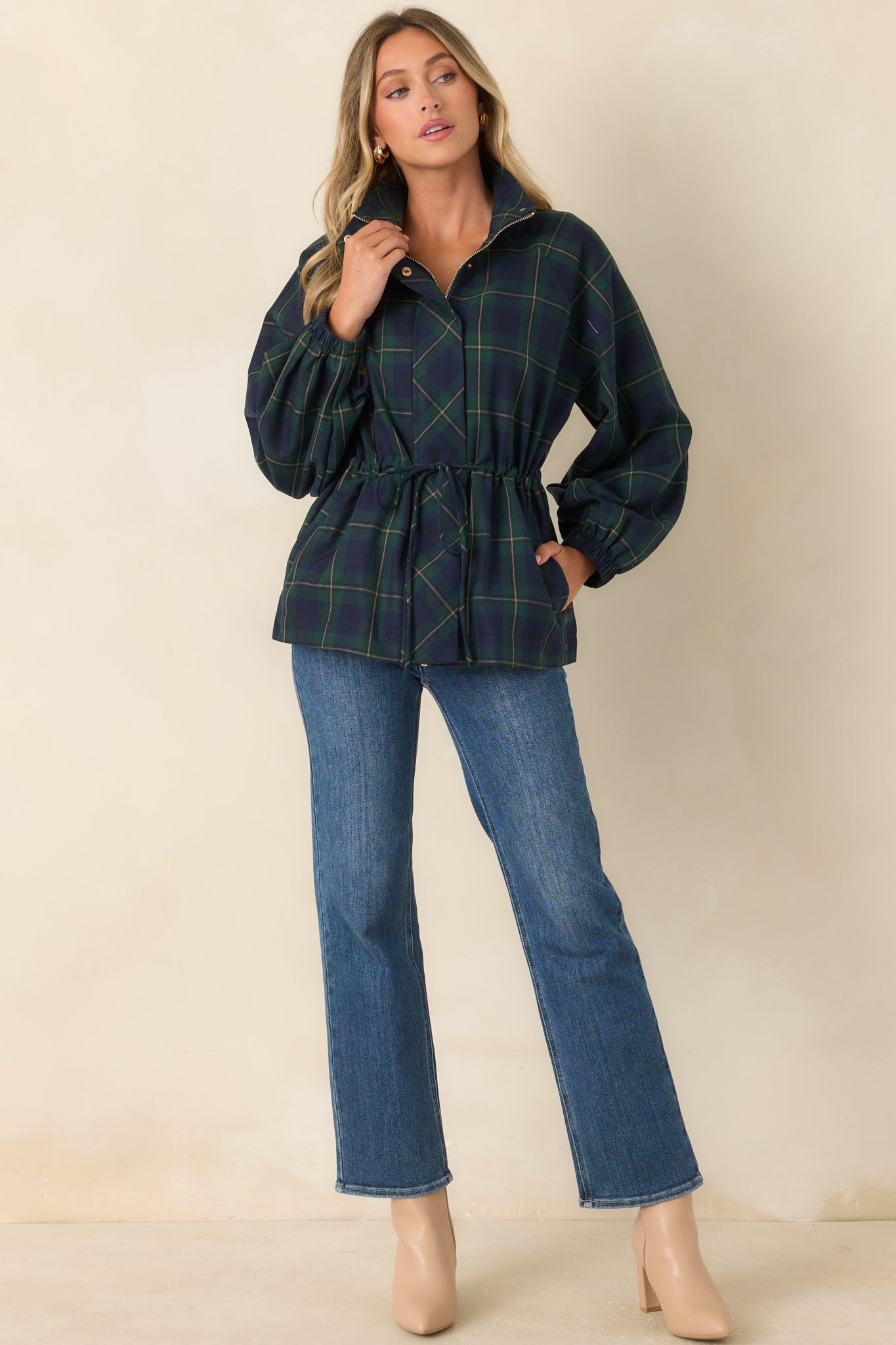 Lightweight jacket featuring a rich green and navy plaid pattern, structured collar, zip-front closure, elastic cuffs, adjustable drawstring waist, and oversized patch pockets.