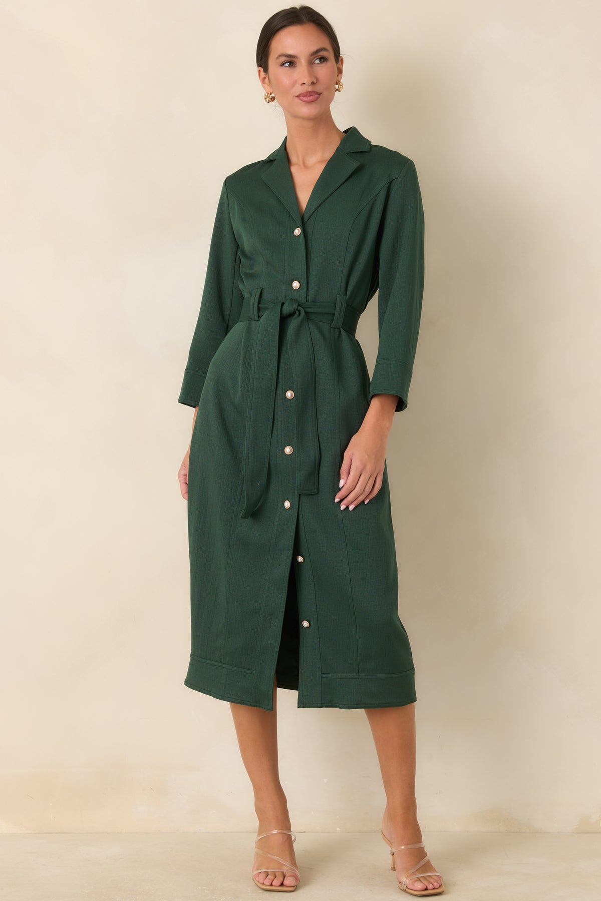 Green midi dress combining a notched collar with a classic straight skirt.