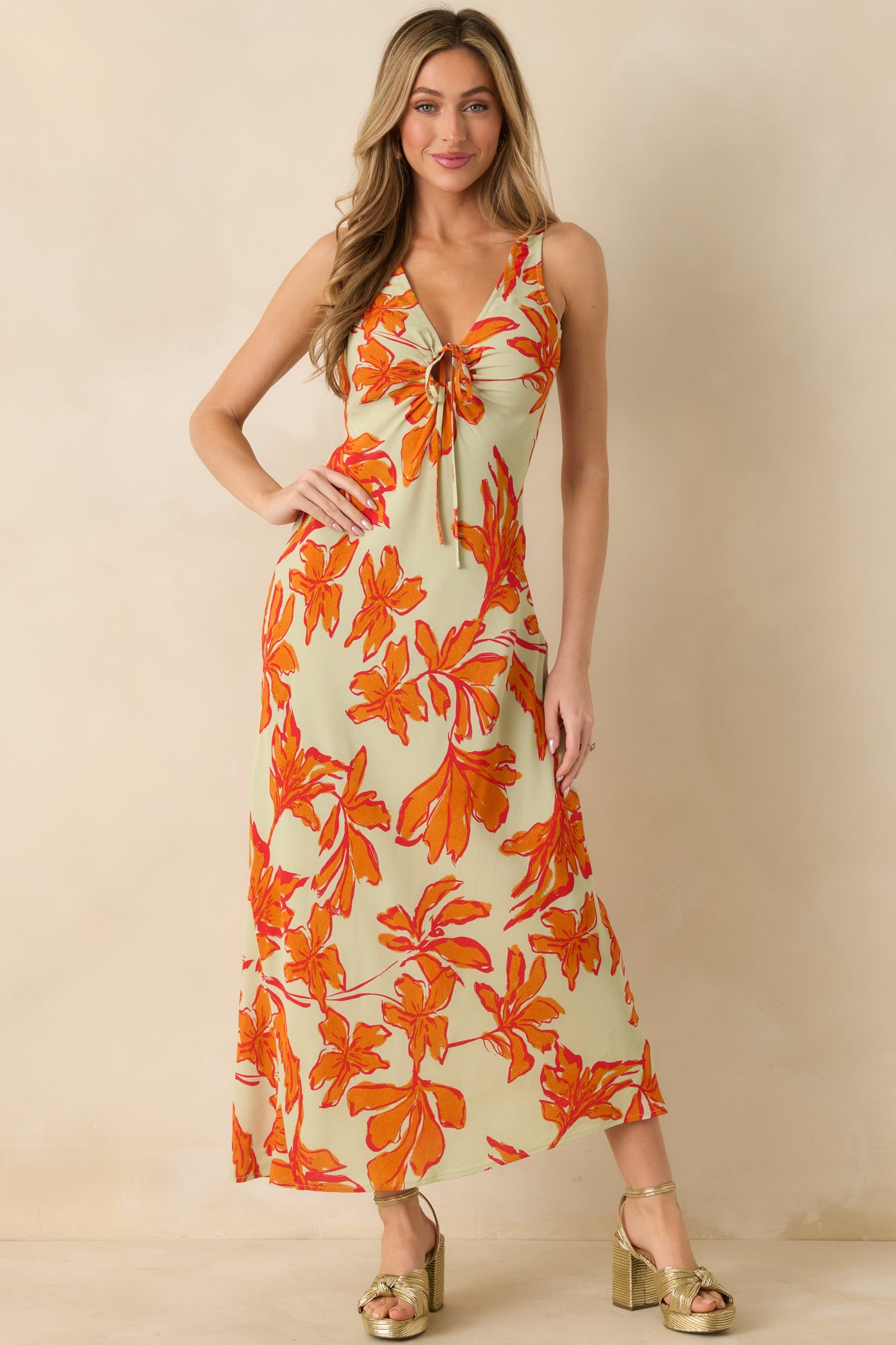 Maxi dress in green and orange florals emphasizing its soft woven fabric.